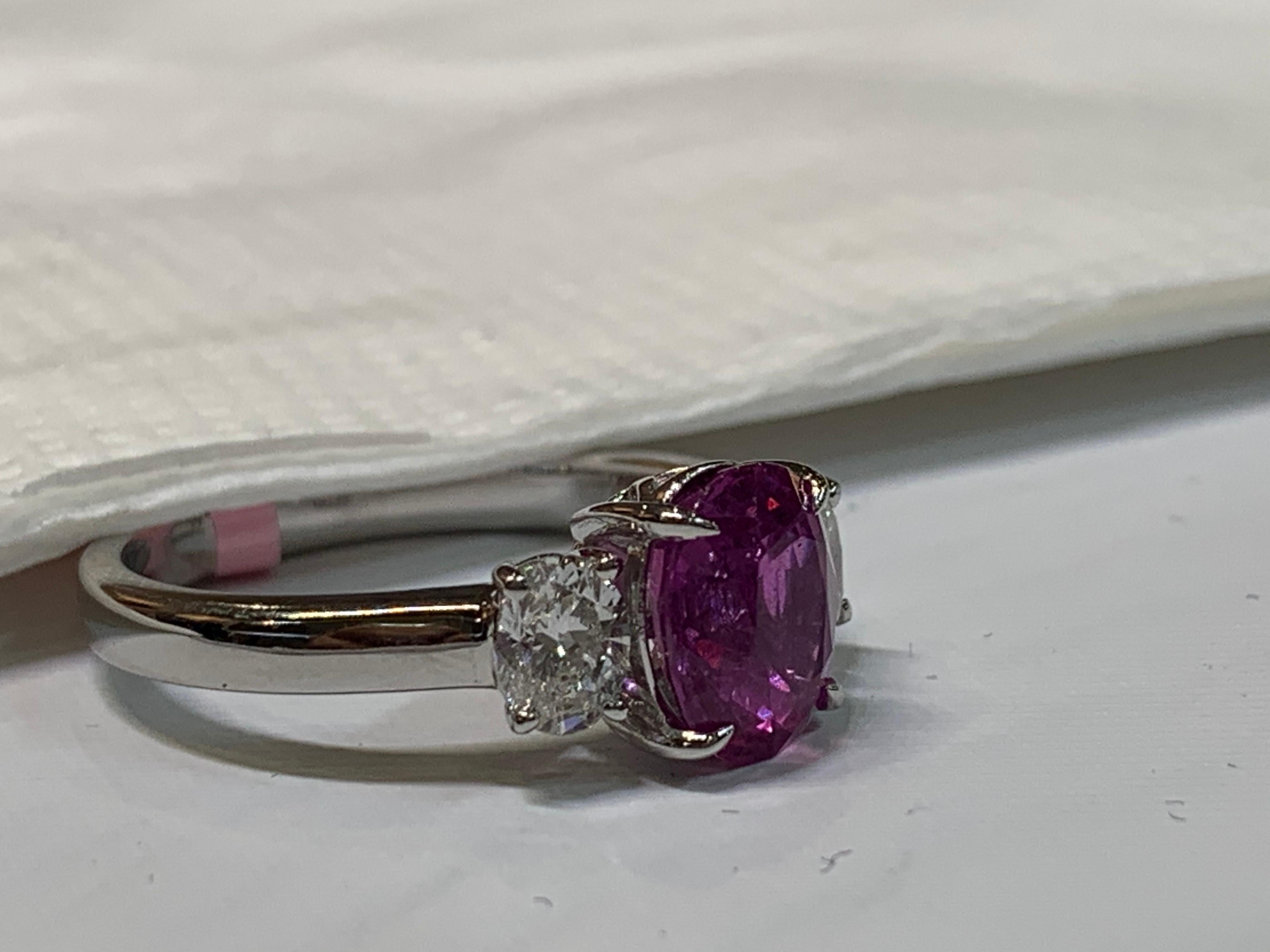 Natural 2.41 Carat pink sapphire Eye clean and Two ova diamonds on either side 0.61 Carat is G-H color and SI quality is handcrafted and set in Platinum.The ring is size 7 but can be resized at near by your jewelry repair store, if needed.