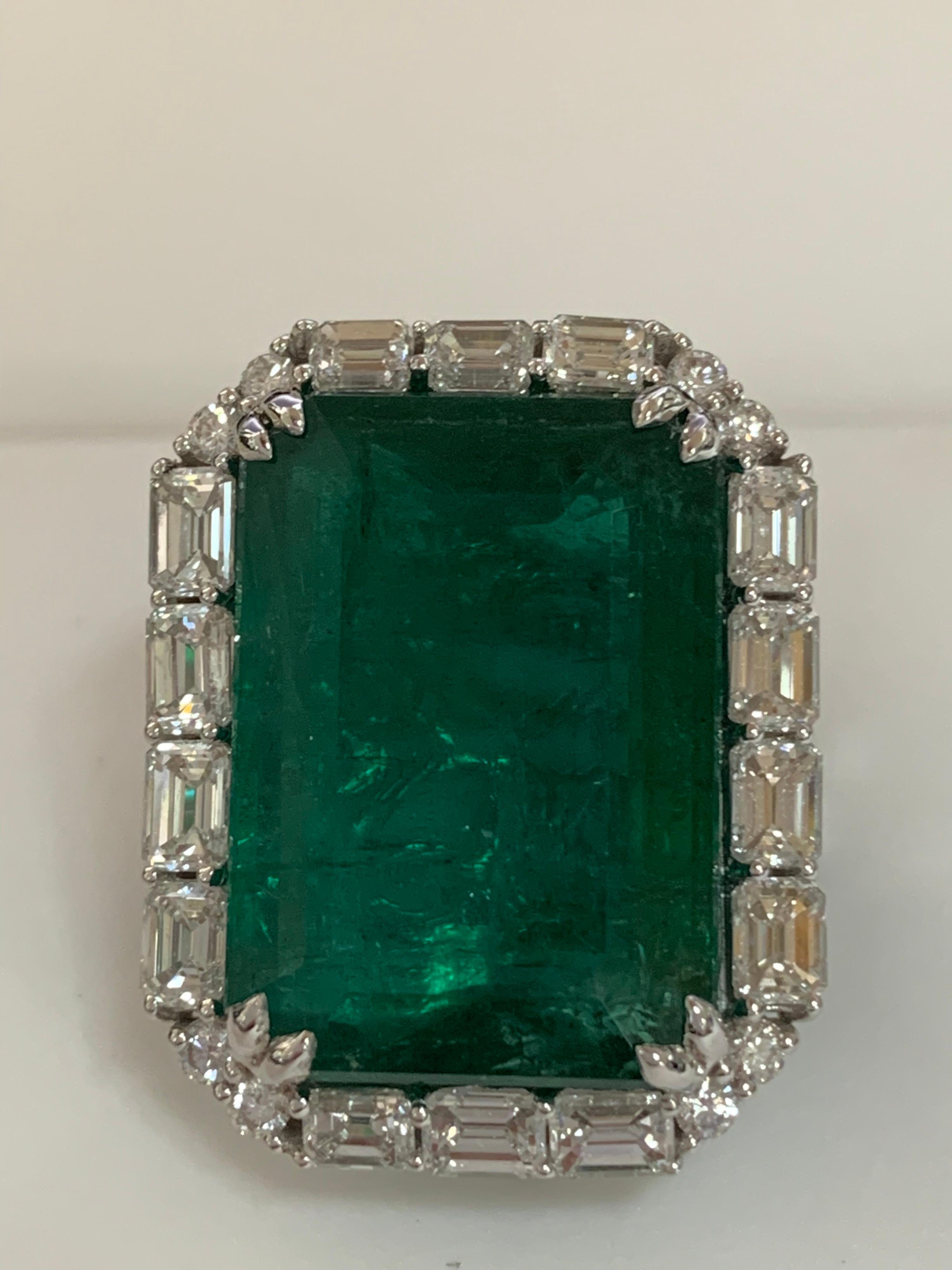 Natural Certified 23.98 Carat Emerald and 5.38 Carat white diamonds set in 18 Karat white gold is one of a kind handcrafted Ring. The ring is size 7 and can be resized if needed. 