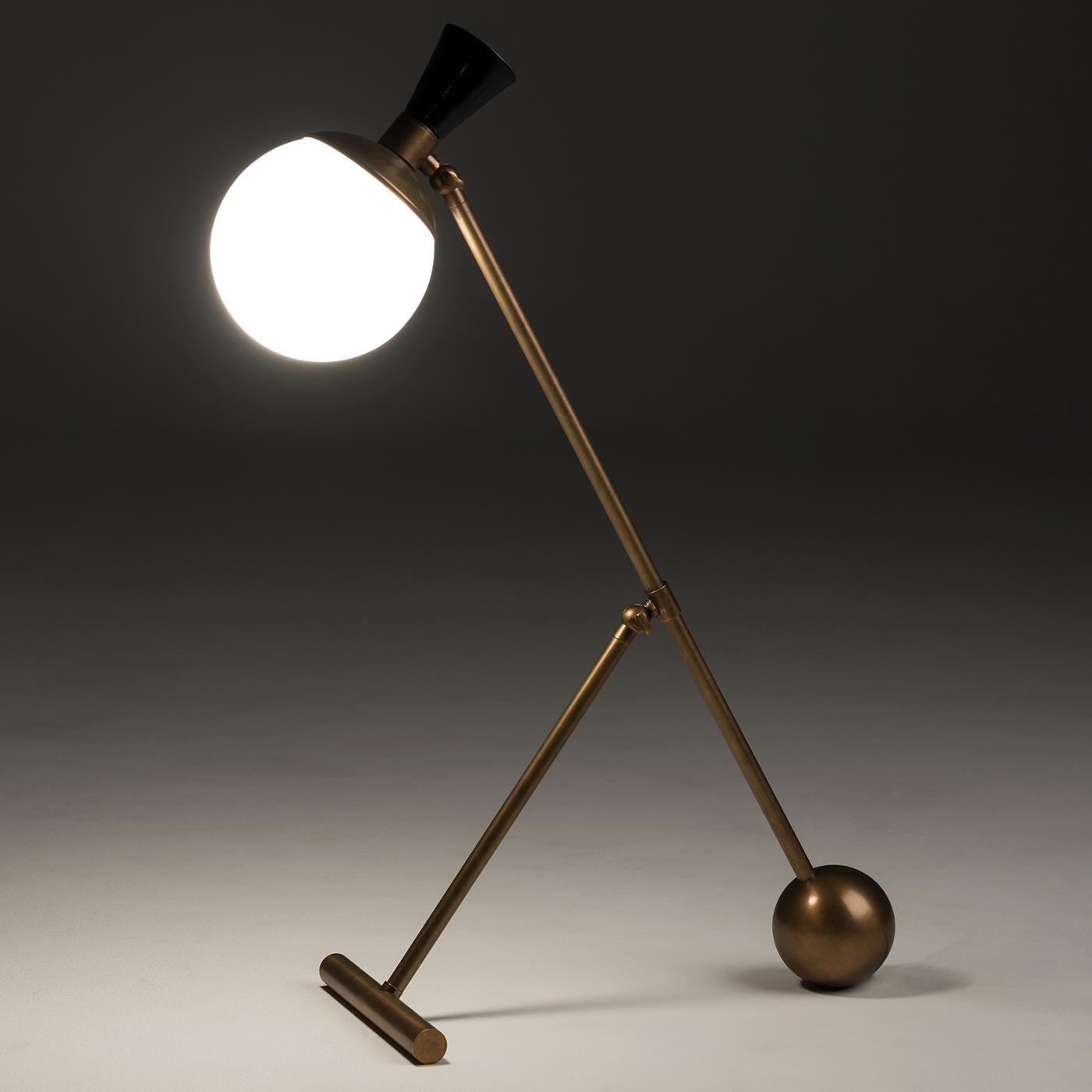 The Igloo Table Lamp is defined by playful use of line and form. A simple yet striking spherical diffuser contrasts with a robust bronze structure, boasting a hand-etched finish for a subtle vintage allure. Emitting a warm, even glow, this modern