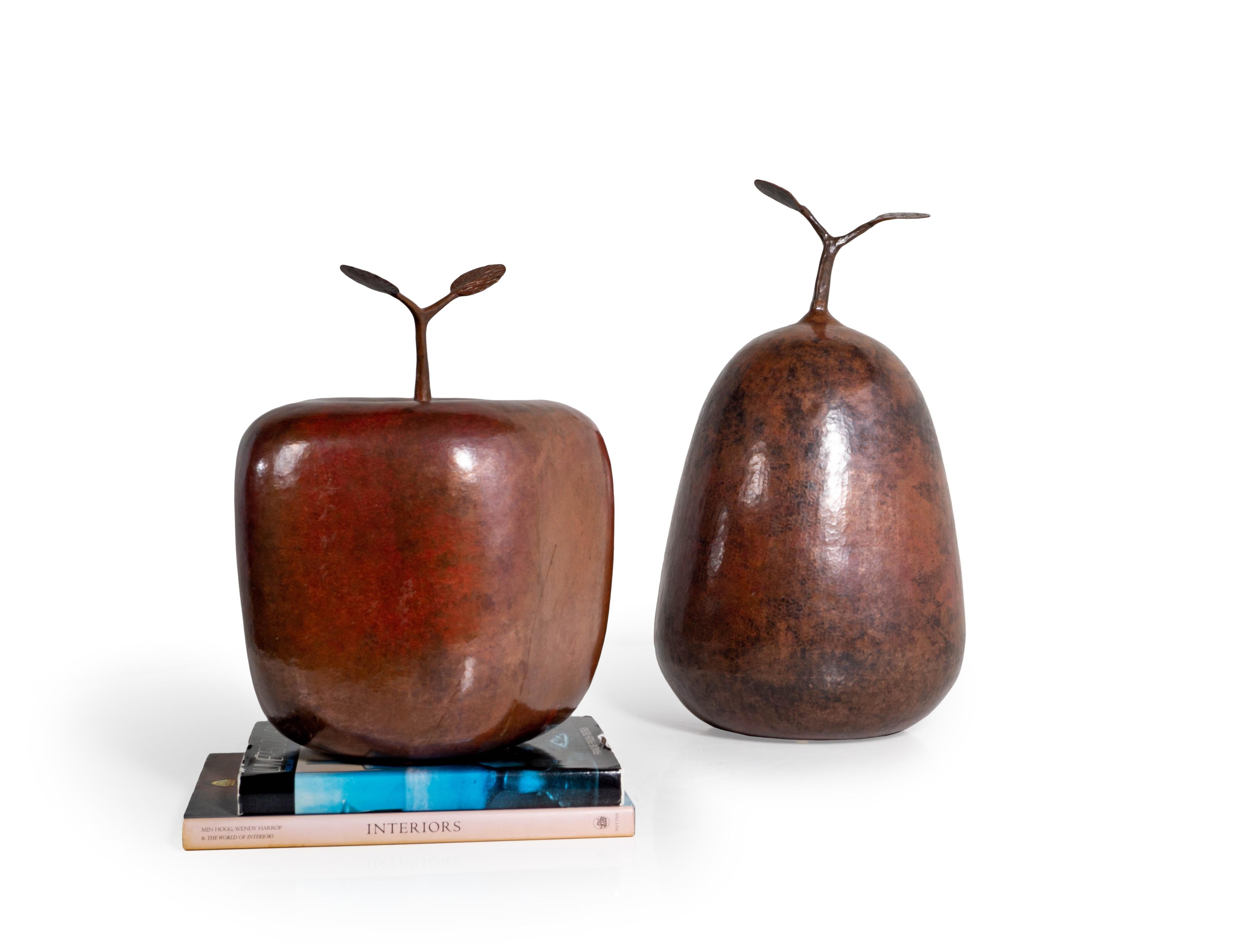 Ignacio Punzo Angel (Mexican, 20th Century) is a master coppersmith. A magnificent set of two Modernist decorative hammered copper still life fruit sculptures, produced 1999. Oversized hollow bodied pear and apple forms. Signed on bottom IGNACIO