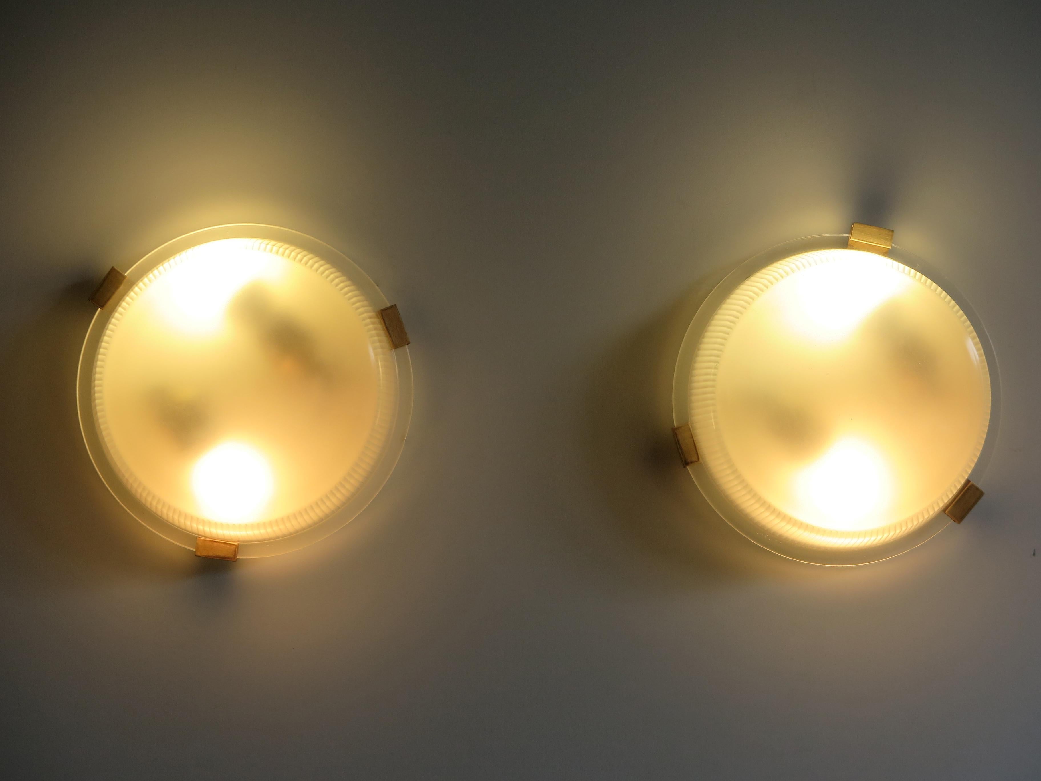 Couple of rare Italian sconces or ceiling lamps designed by famous designer Ignazio Gardella for Azucena, brass structure and diffusers in satin-finish molded glass, manufacturer’s mark engraved under the structure, 1950s.

Please note that the