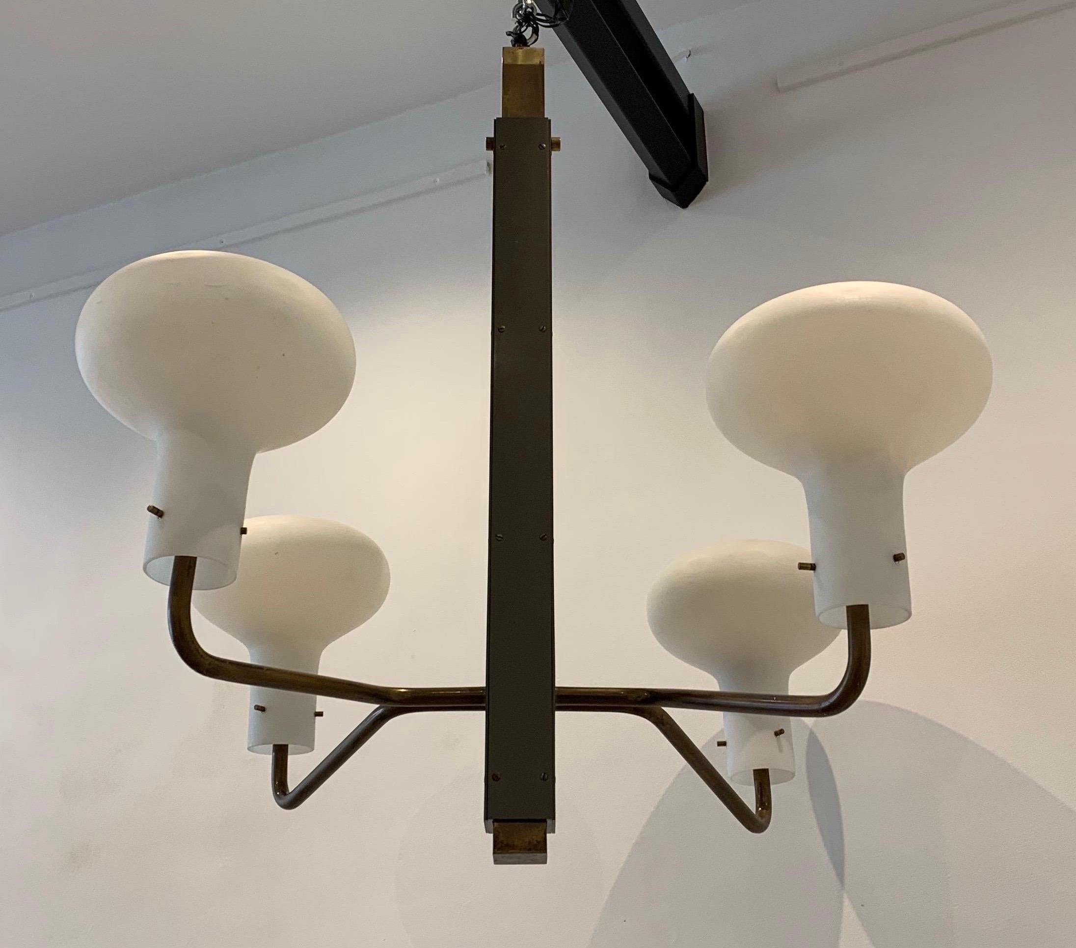 This a rare four-arm chandelier was designed by Ignazio Gardella and manufactured by Azucena in Milan, Italy, in 1958. 

Please note the chandelier offers ten possibilities of height ranging from 90cm to 130cm. There is system that allows the