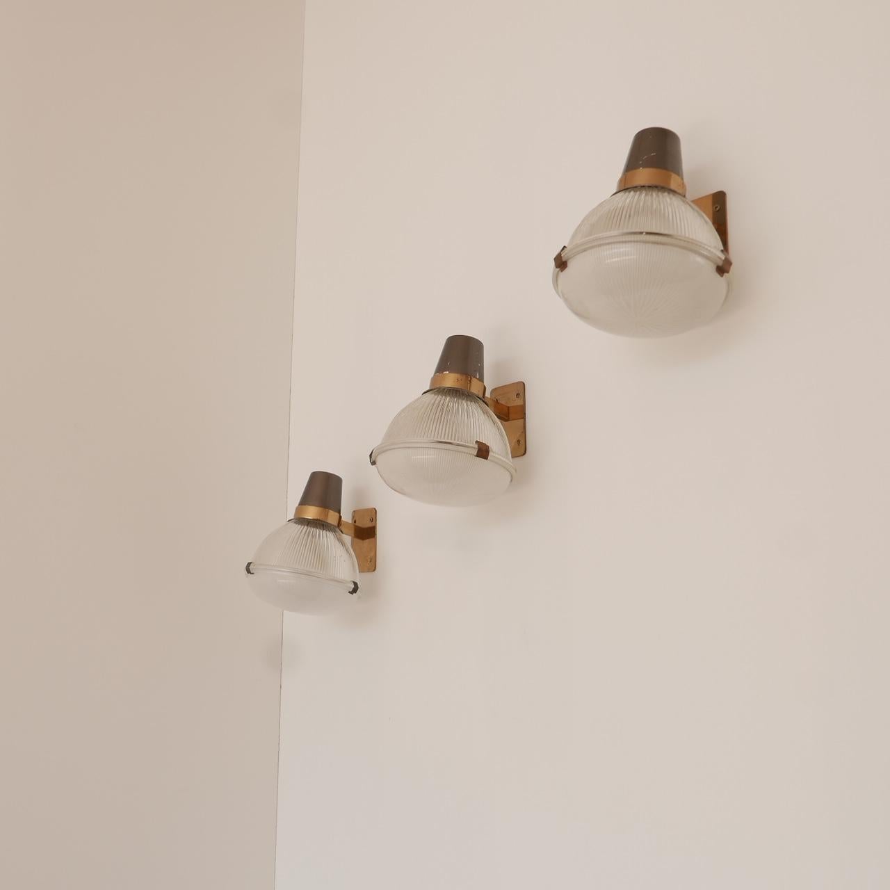 *3 available 
Italian Midcentury wall lights by Ignazio Gardella for Azucena,

circa 1960s, Italy.

They can be hung up or down.

LP6 model.

Glass and brass. Re-wired and PAT tested. 

Generally good condition, some clips lacking, some loss to