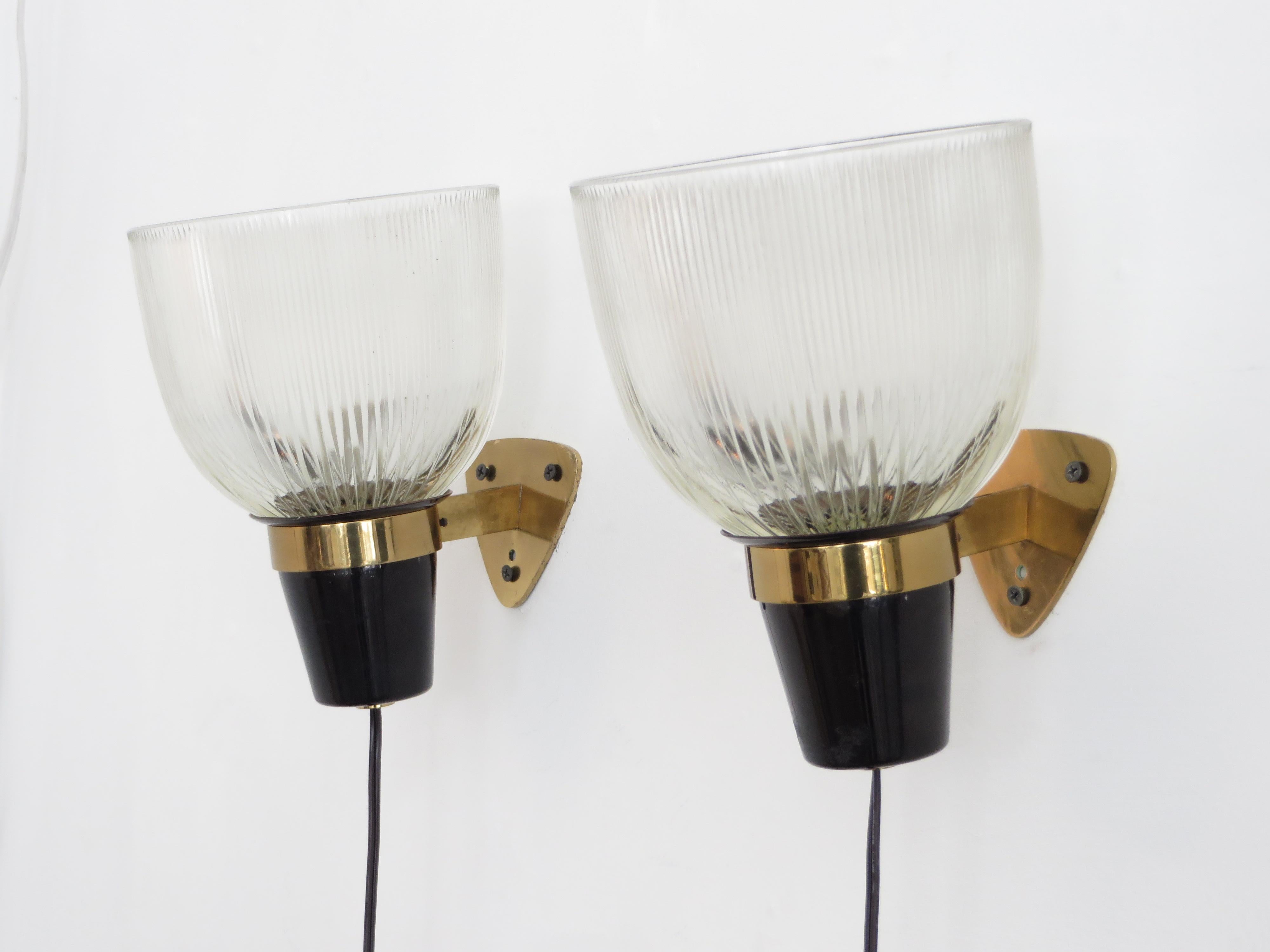 Architect and lighting designer Ignazio Gardella Italian sconces for Azucena.
Opaline Halophane pressed glass, black painted metal and brass arms, circa 1950.
This is a vintage pair and stamped Azucena on the back of the wall plate. Rewired for