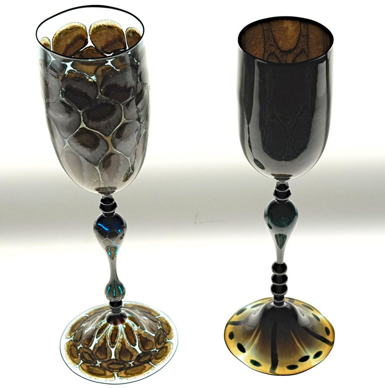 Two collector's goblet. 

The finesse and details of his pieces are excellent. See the photos. 
Finish is different. One has a sort of feather patter and has aquamarine light transparency. The other is darker and from outside the cup might look