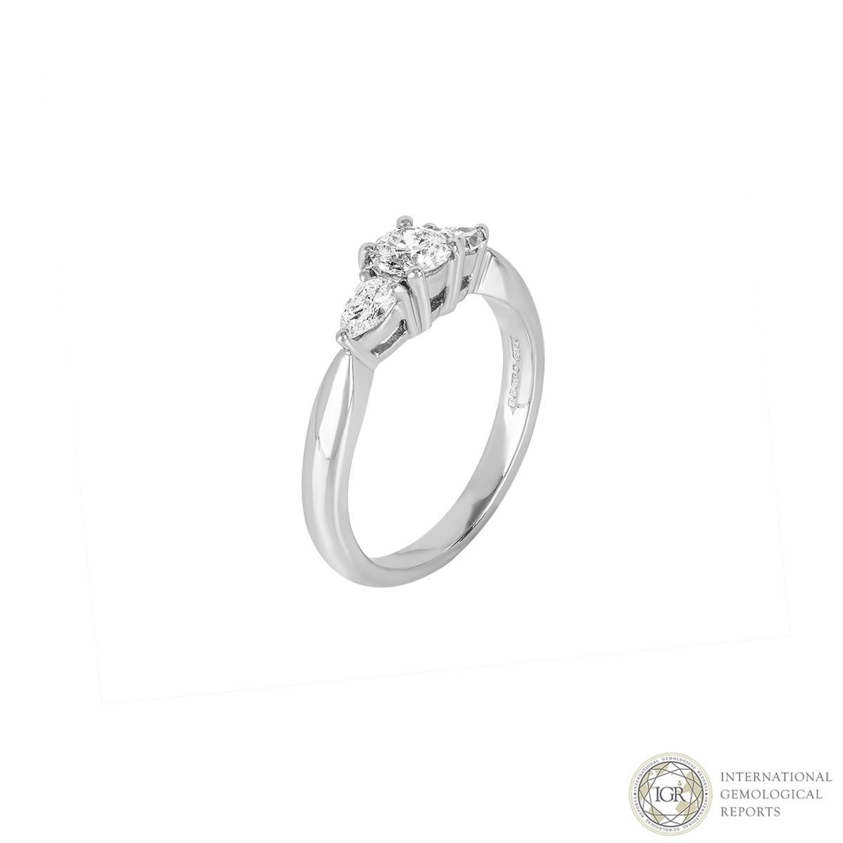 An elegant three stone diamond ring in platinum. The central round brilliant cut diamond weighs 0.37ct, G colour and SI2 clarity. The two pear shape side stones both weigh 0.14ct each well matched in colour and clarity to the central diamond. The