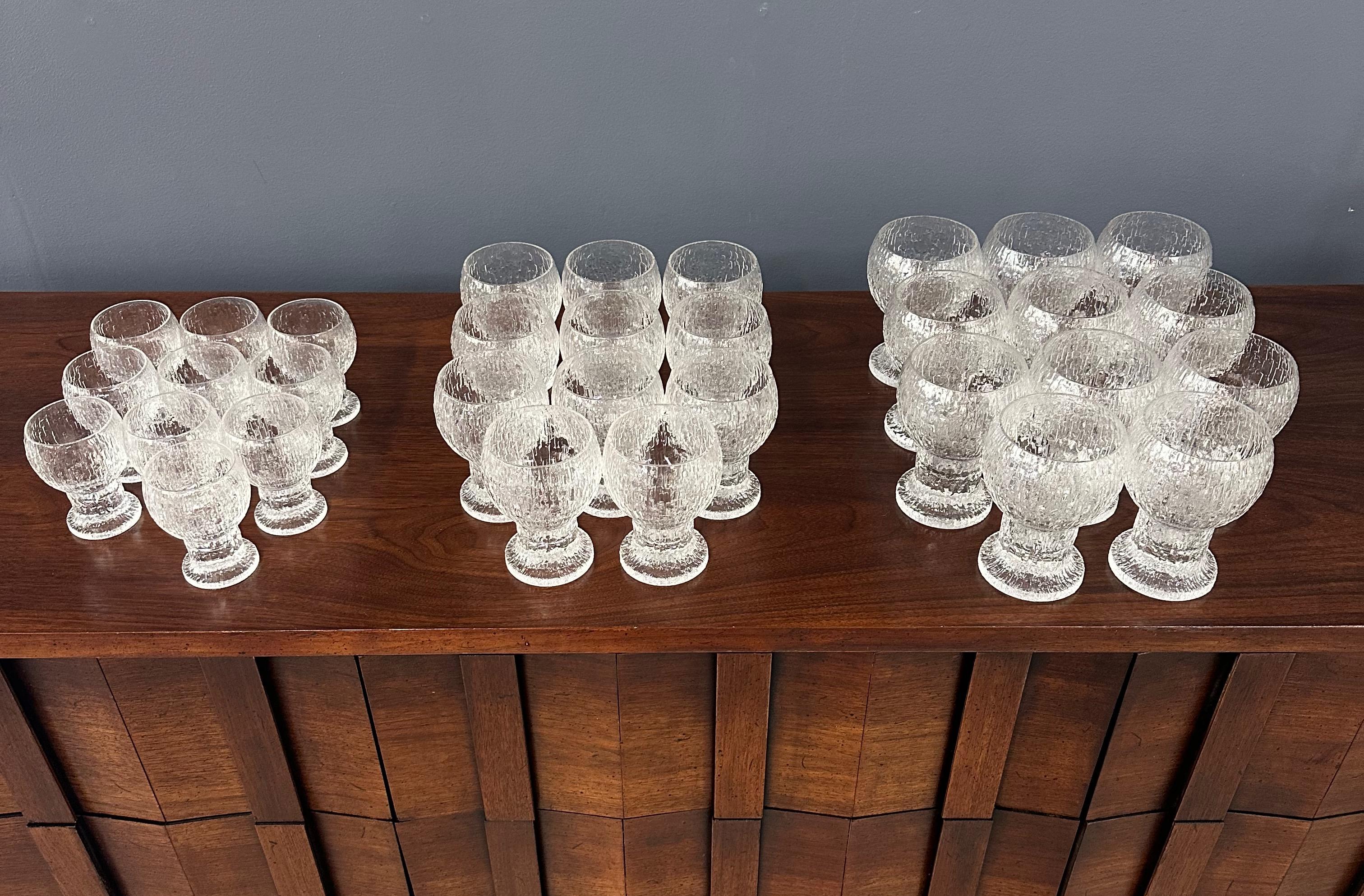 Expertly crafted by renowned designer Timo Sarpaneva for Iittala Finland, this set of 32 stemware pieces includes water, wine, and cordial that combine form and function in a seamless, modern design. Perfect for entertaining or everyday use, these