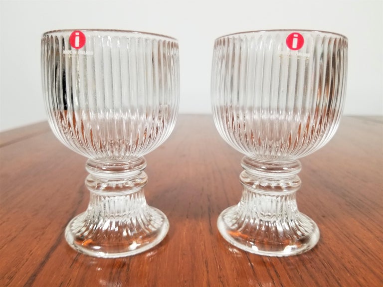 Midcentury 1970s pair of cordial or sherry glasses designed by Valto Kokomo for iittala. Never used and still in original box. Each glass still retains original sticker markings. Excellent condition.