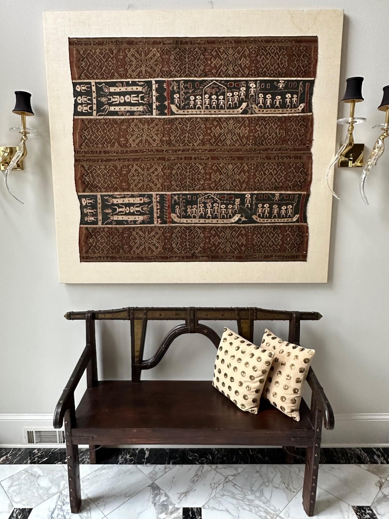  An Indonesia textile panel professionally presented on a linen canvas. It can be taken off from the canvas for easy and economical shipping upon request. The textile was joined with old woven ikat panels and apparently newer embroidery panels in