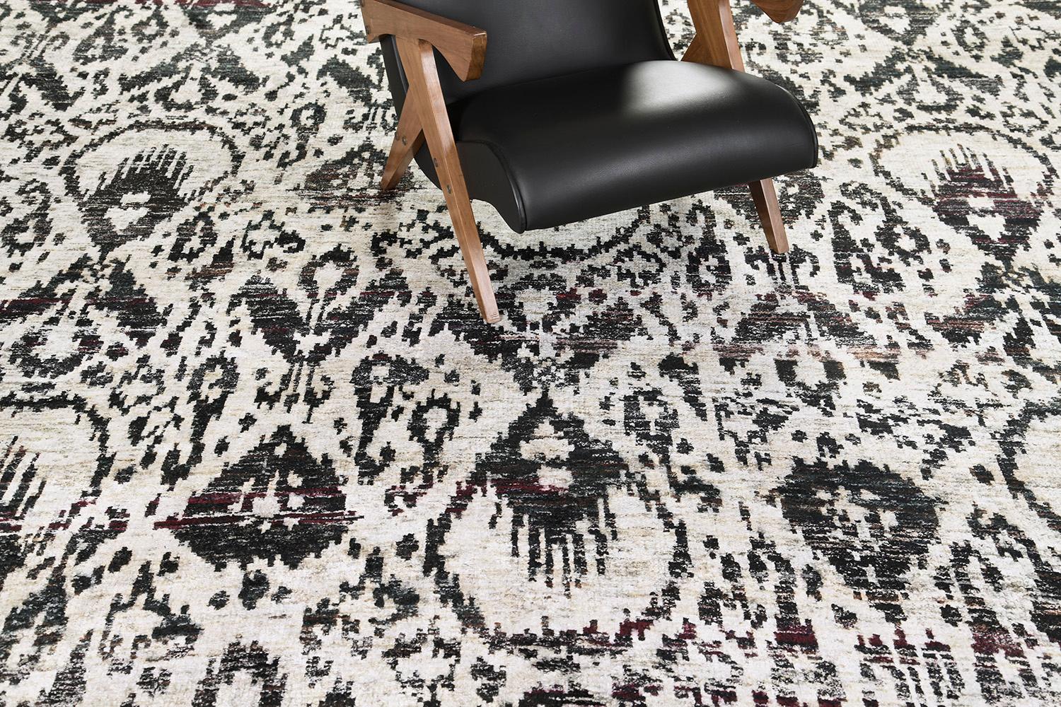 Balancing a bold and beguiling style, this Ikat design rug made of bamboo silk elegantly displays an artistic vibe. A distinct repetitive Ikat pattern runs along the ecru field. A perfect way to give your room a character is found in this masterful