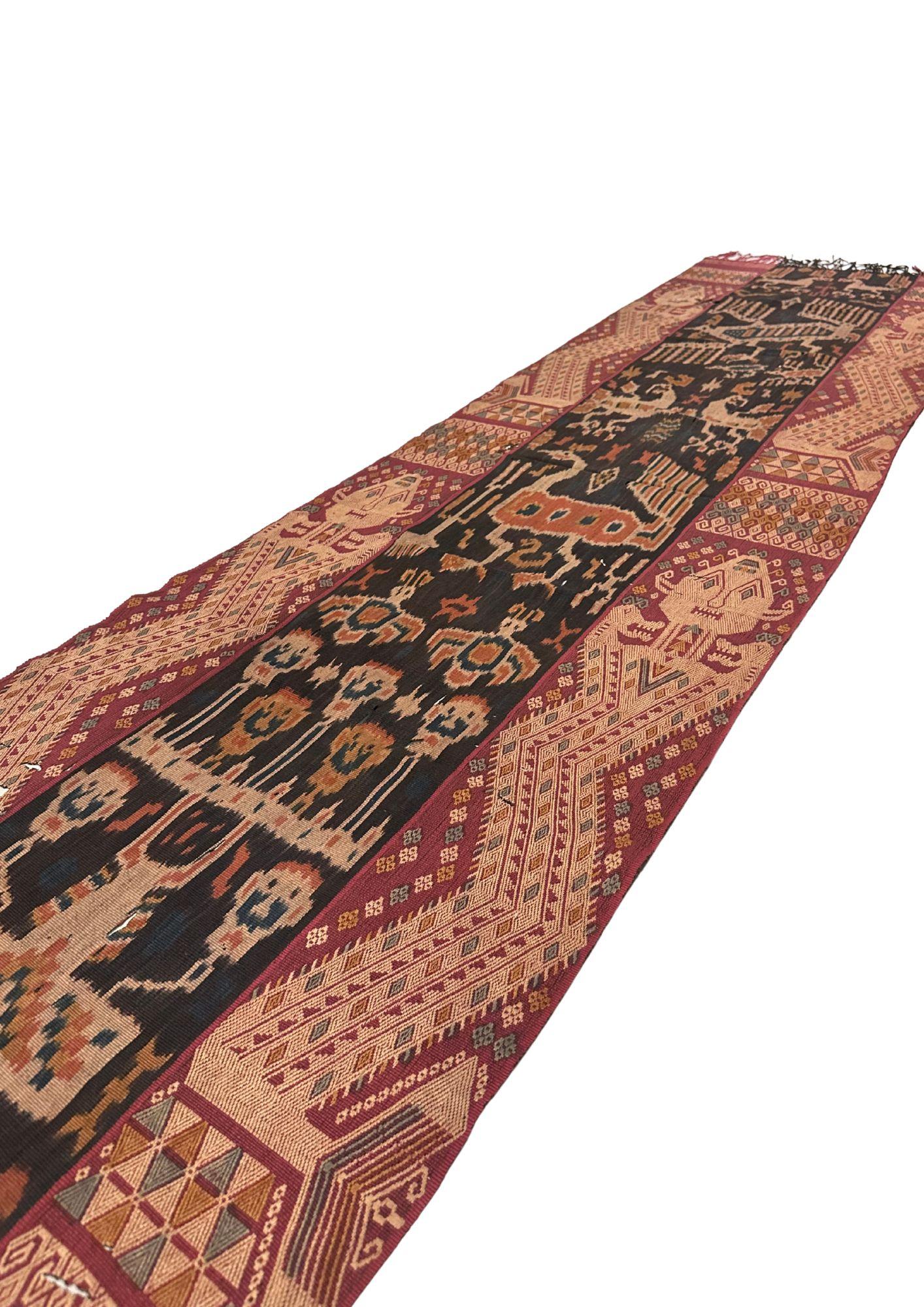 This exquisite ikat textile from Sumba Island, Indonesia, is a handwoven treasure that speaks to centuries of tradition, artistry, and cultural depth. Crafted by skilled artisans using age-old techniques passed down through generations, the fabric