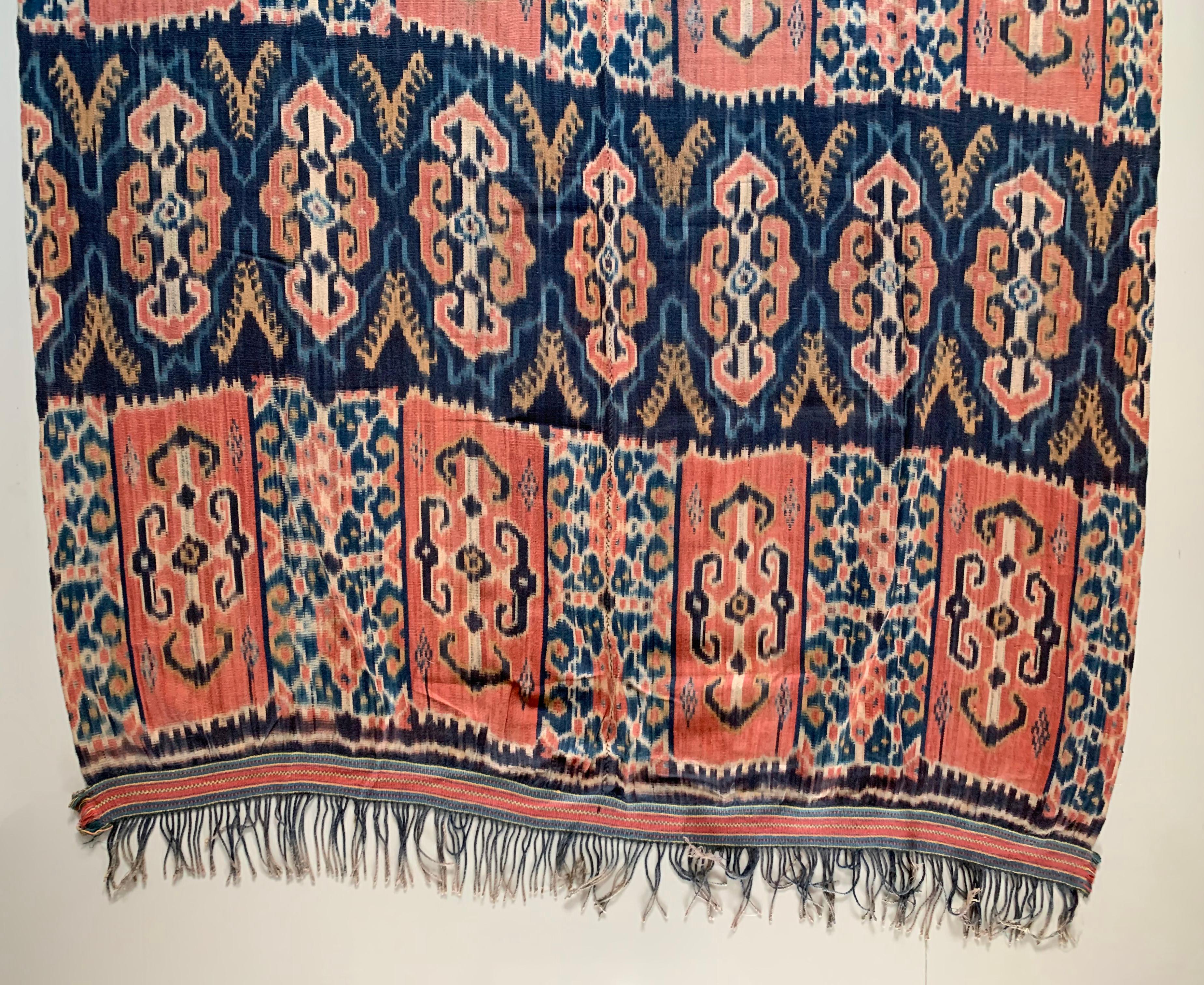 This Ikat textile originates from the Island of Sumba, Indonesia. It is hand-woven using naturally dyed yarns via a method passed on through generations. It features a stunning array of distinct tribal patterns. 

This is an exceptionally long