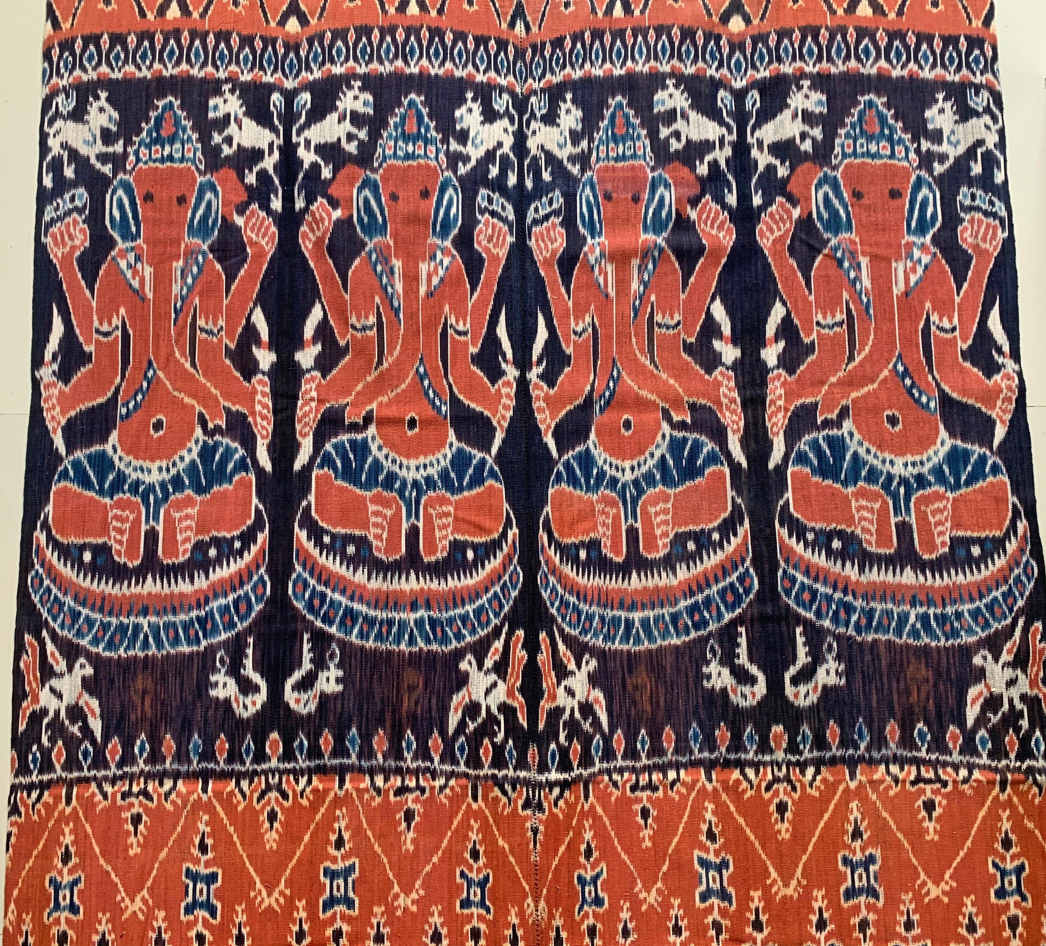 This Ikat textile originates from the Island of Sumba, Indonesia. It is hand-woven using naturally dyed yarns via a method passed on through generations. It features a stunning array of distinct tribal patterns. 

This is an exceptionally long