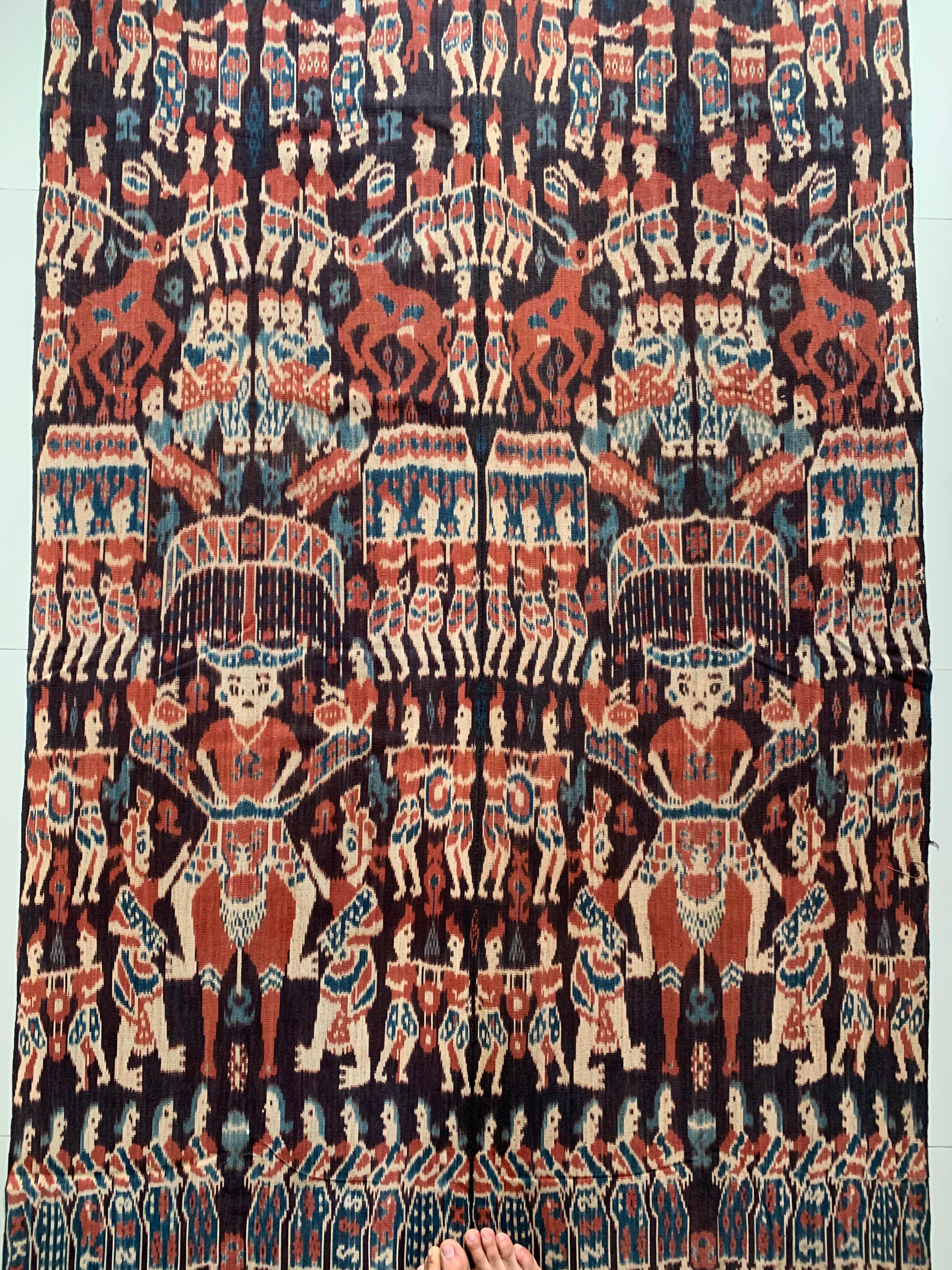 This Ikat textile originates from the Island of Sumba, Indonesia. It is hand-woven using naturally dyed yarns via a method passed on through generations. It features a stunning array of distinct tribal patterns as well as human & buffalo motifs.