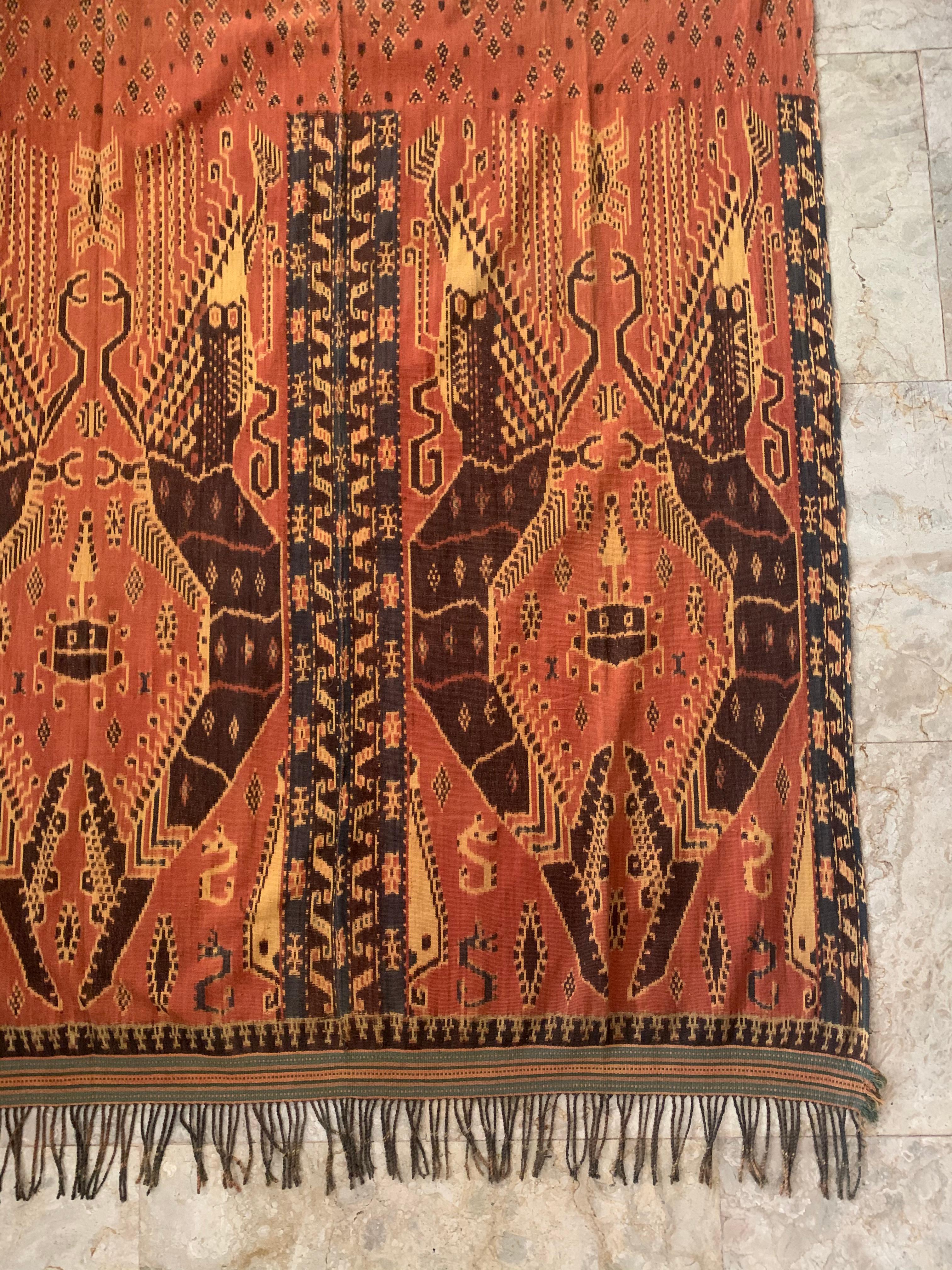 This Ikat textile originates from the Island of Sumba, Indonesia. It is hand-woven using naturally dyed yarns via a method passed on through generations. It features a stunning array of distinct tribal patterns as well as lobster motifs. This ikat