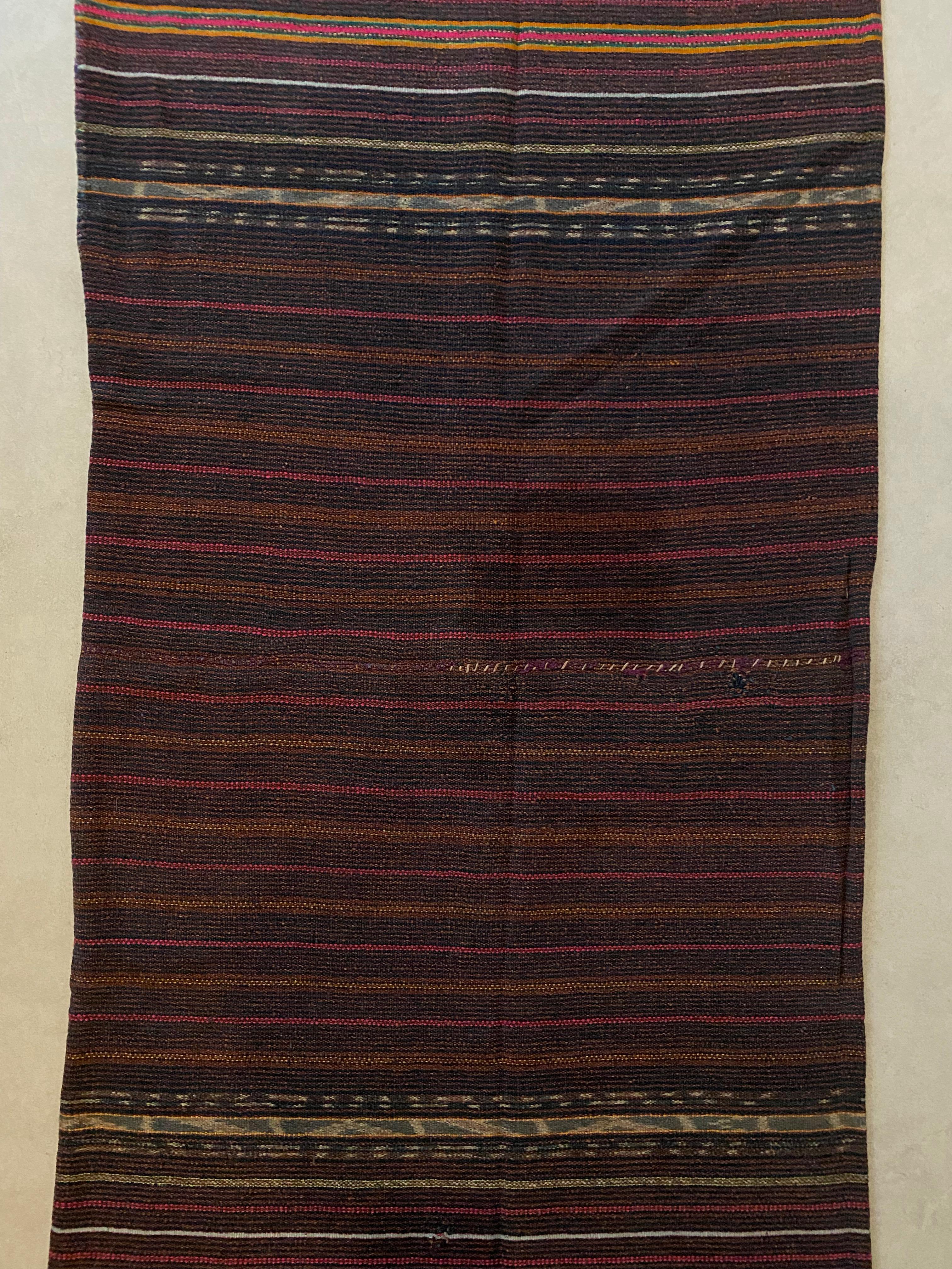This Ikat textile originates from the Island of Timor, Indonesia. It is hand-woven using naturally dyed yarns via a method passed on through generations. The dark blue foreground brings to life the array of coloured detailing and distinct tribal