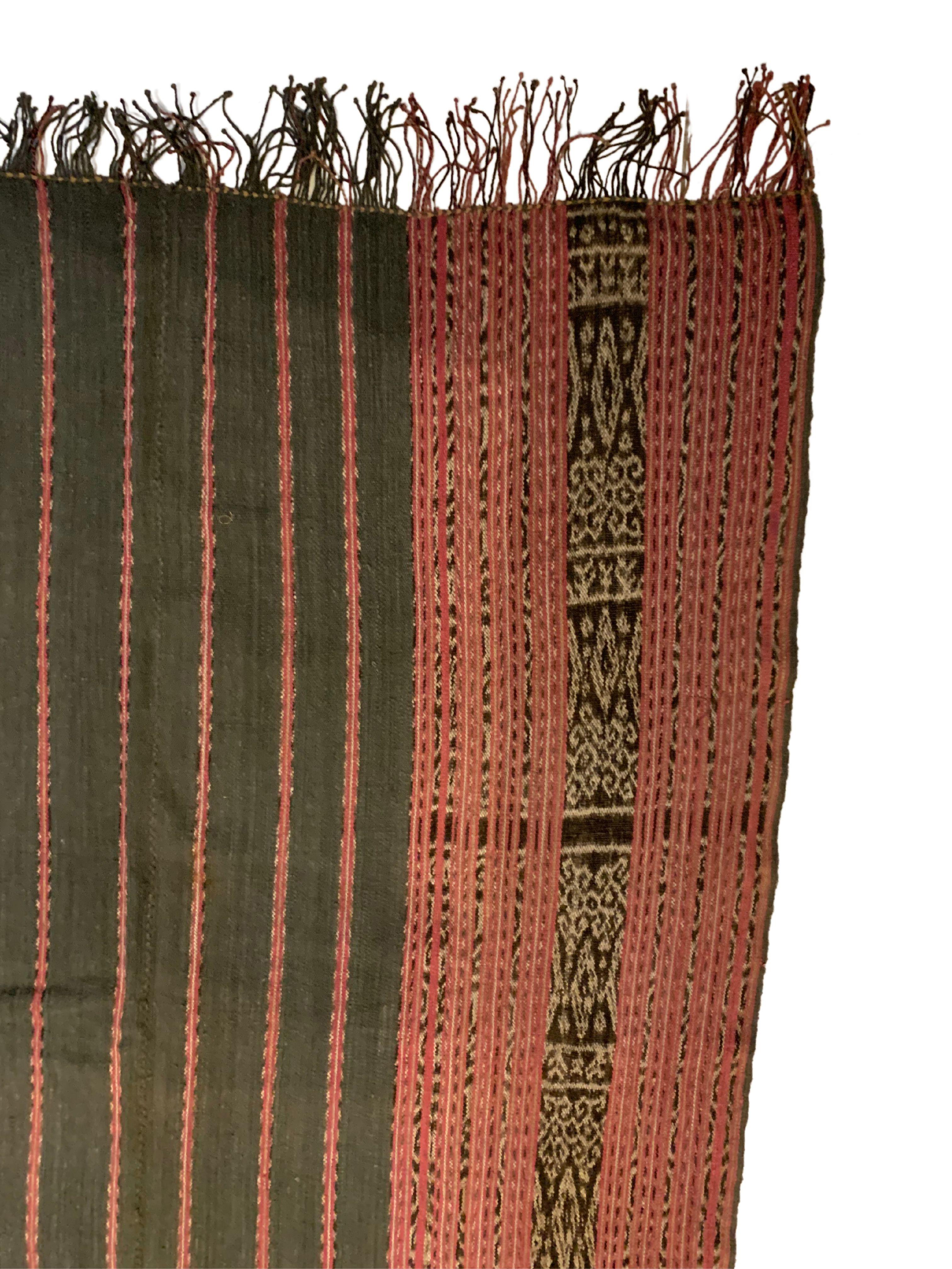 An wonderful example of a west timor ikat textile. It is hand-woven using naturally dyed yarns via a method passed on through generations. It features a stunning array of distinct tribal patterns and bright colours. Textiles such as this one are