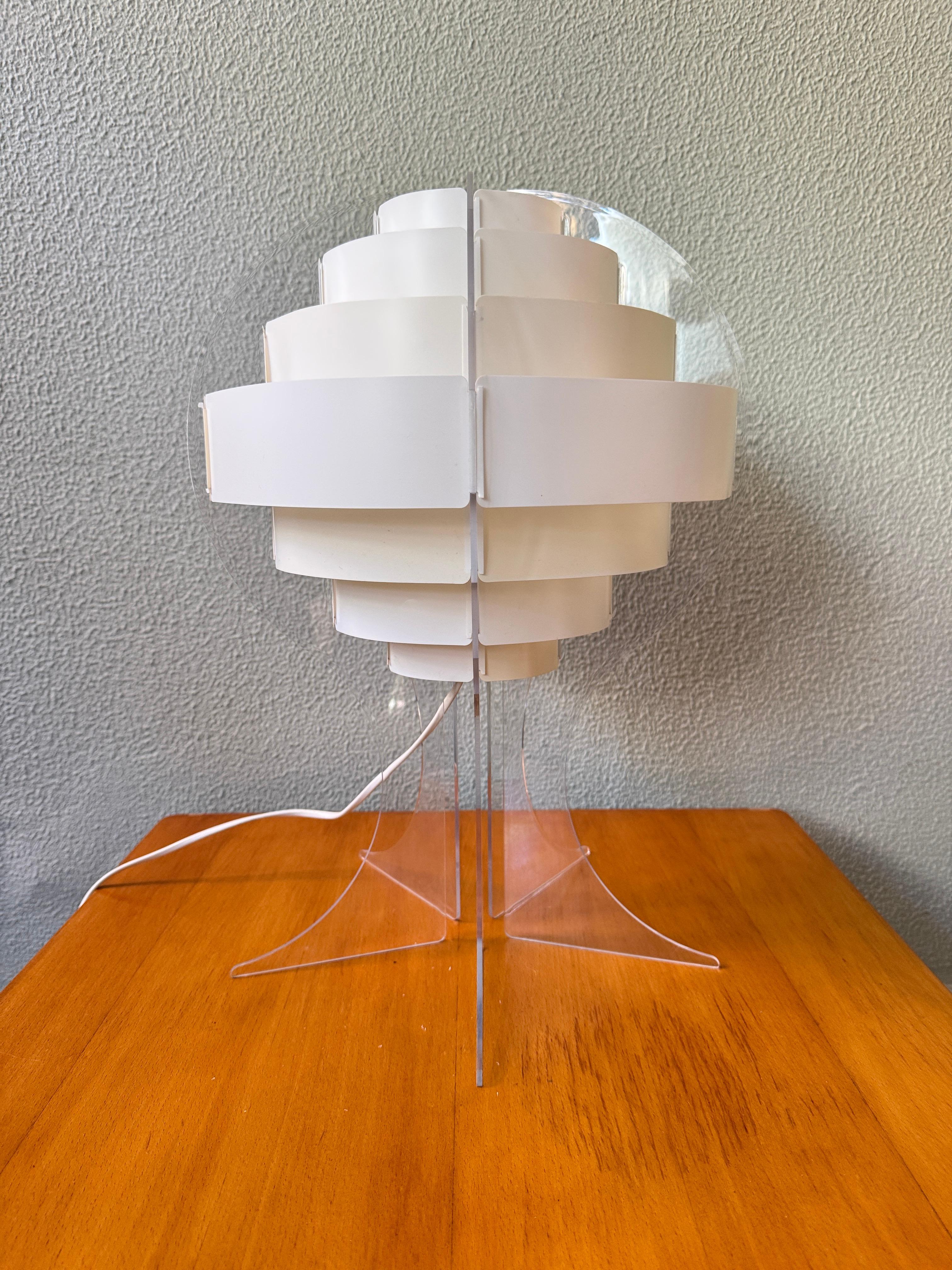Originally designed by Flemming Brylle and Preben Jacobsen for Quality System, Denmark, in the 1960s, this sculptural table lamp was reissued by IKEA in the early 2000s under the name Lakane Strips. The design is a testament to the timelessness of
