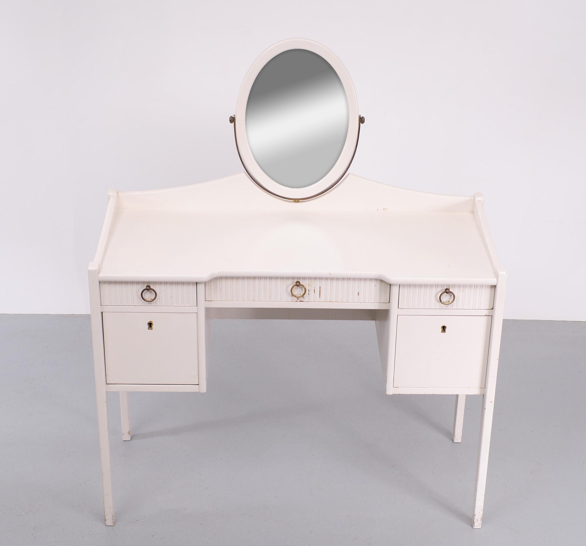 Must love this vanity so typical 1950s .Made by Ikea, Möbler.  In the 1950s 
just a small Furniture seller in Sweden. This Little Vanity comes with Three drawers on top and one larger drawer on the right and on the left a pull down door, one