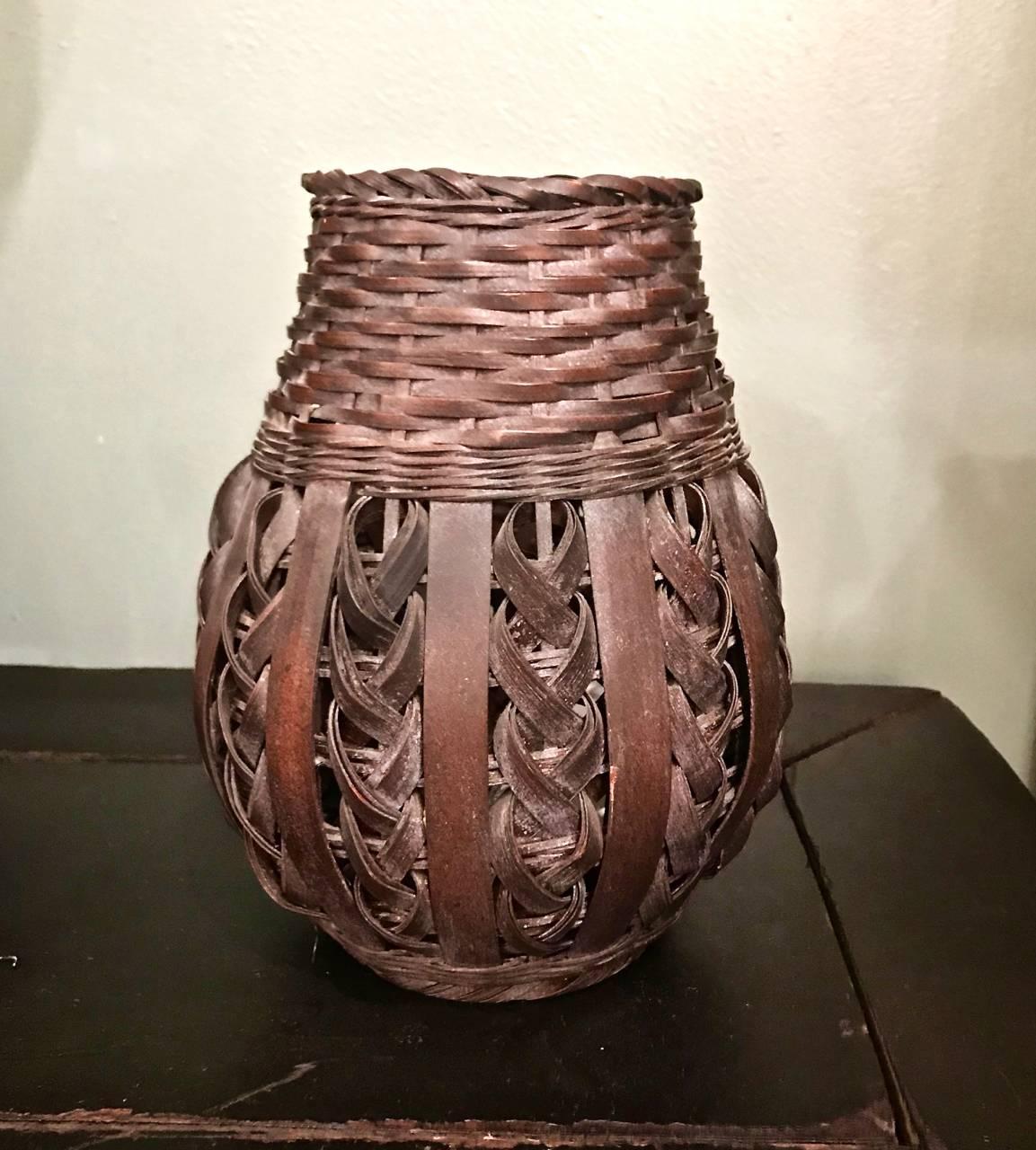 Charming Ikebana woven bamboo basket that dates to the first half of the 20th century. The basket is in overall good condition and includes a liner, which is a replacement.