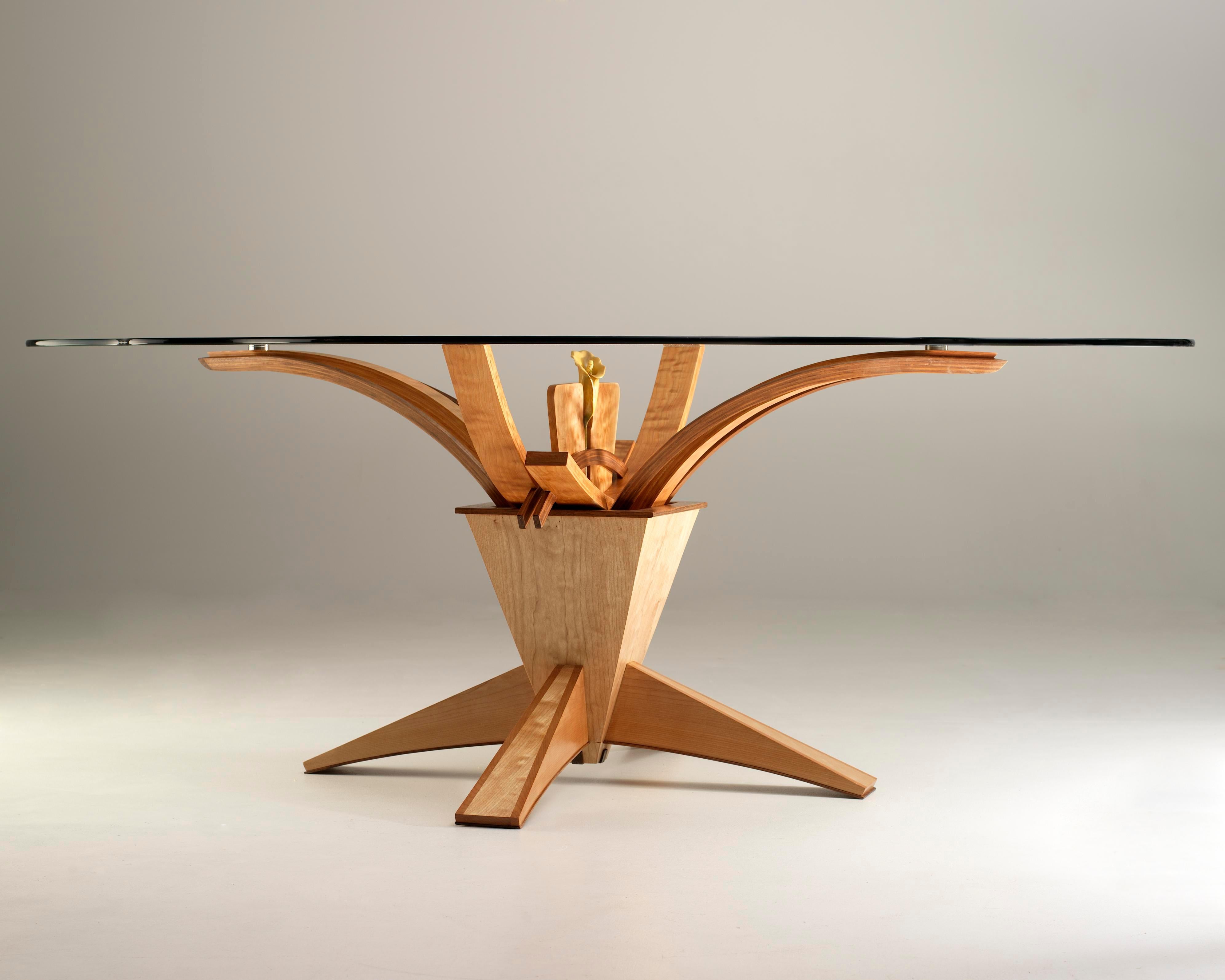 This stunning Ikebana inspired Calla Lilly dining table is a unique one-of-a-kind creation. A custom shaped glass top finishes off this exquisite conversation piece. This table is perfect with six seats but could work with eight smaller chairs as
