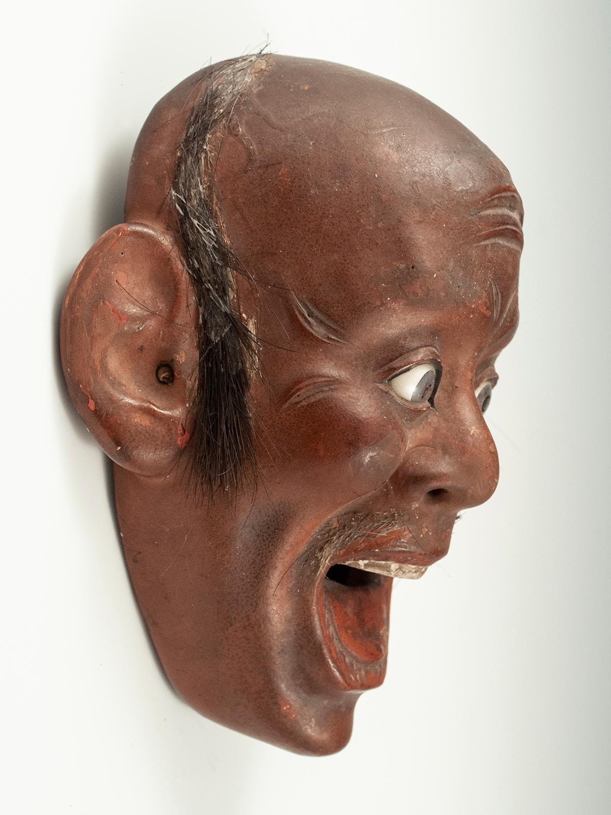 Iki Ningyo Face, Meiji period, Japan

A small and highly animated example of iki-ningyo (living doll) face from Japan. This one has inset glass eyes and bits of animal or human hair applied to upper lip and hairline. In good shape, with one