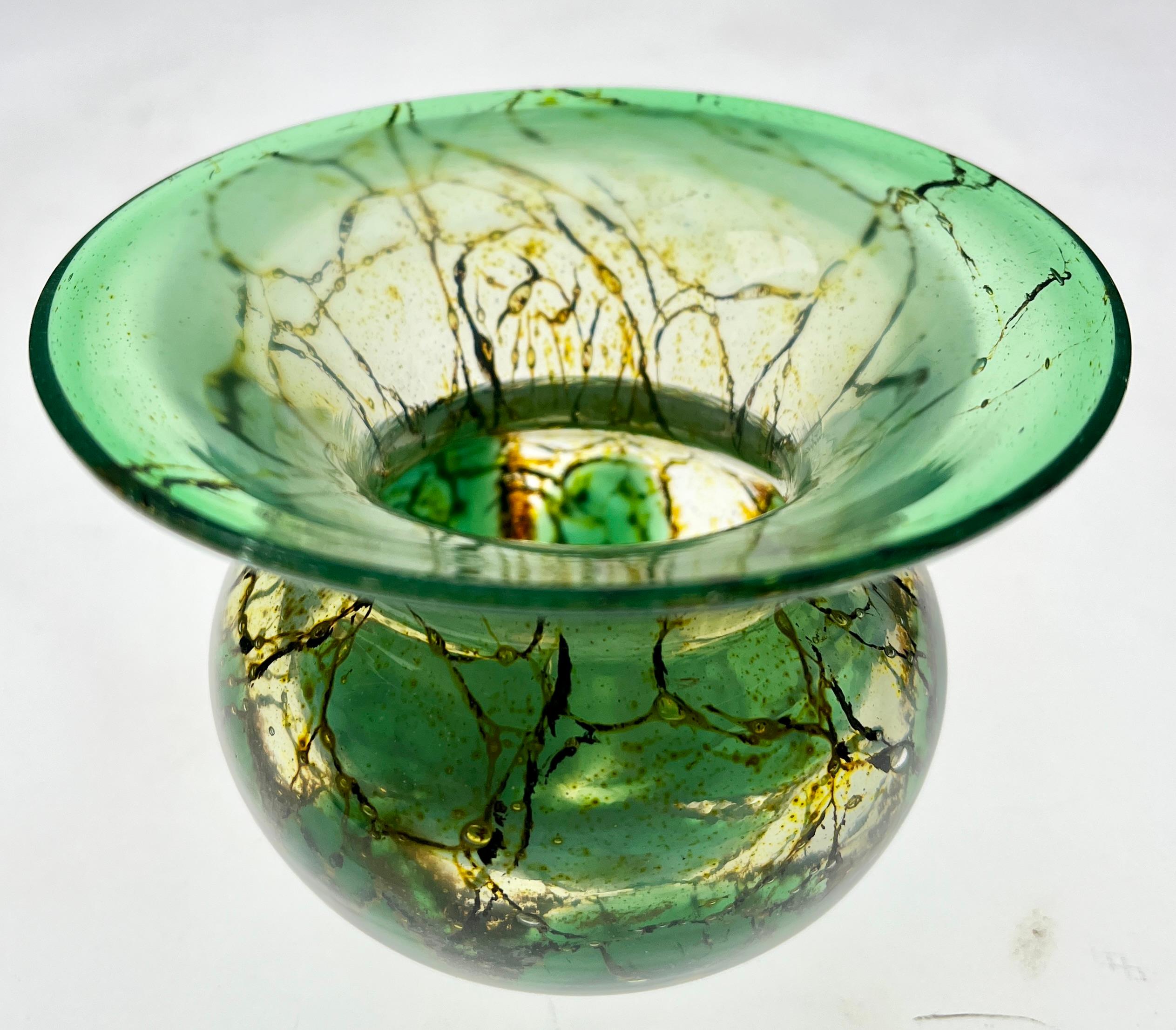 WMF 'Ikora' small crackled art glass vase
German glass bowl by Karl Wiedmann for WMF Ikora, 1930s Baushaus Art Deco.

A decorative 'Ikora' glass vase, produced, by WMF (Wurttembergische Metallwarenfabrik) in Germany.
With crackled details in green