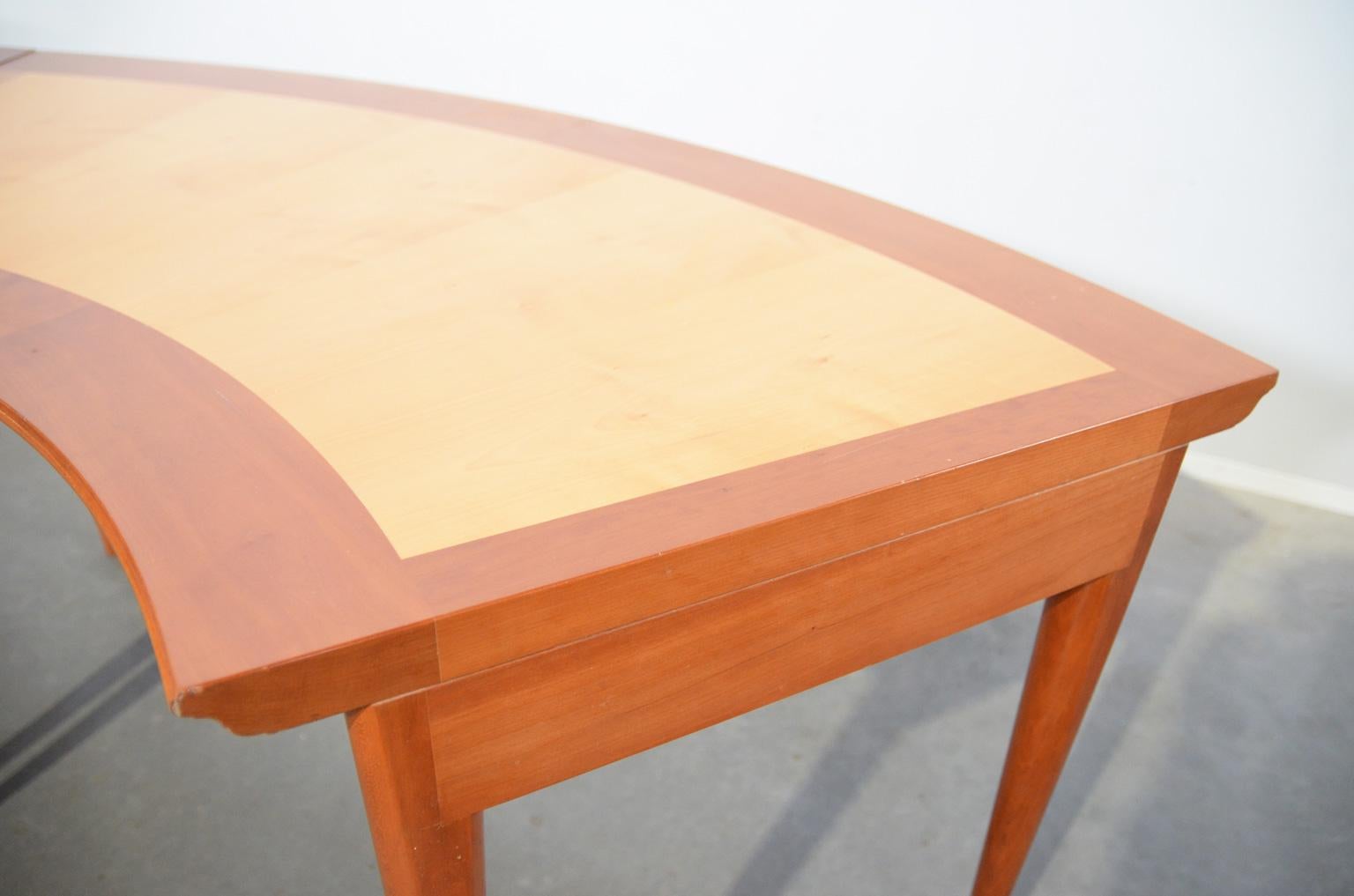 This late 20th century Il Circolo della Tavola table by Adolfo Natalini for Meccani Arredamenti, is made of two different kinds of wood (cherry and pear). The remarkable lines of the table are emphasized bij the cherrywood which is used for the