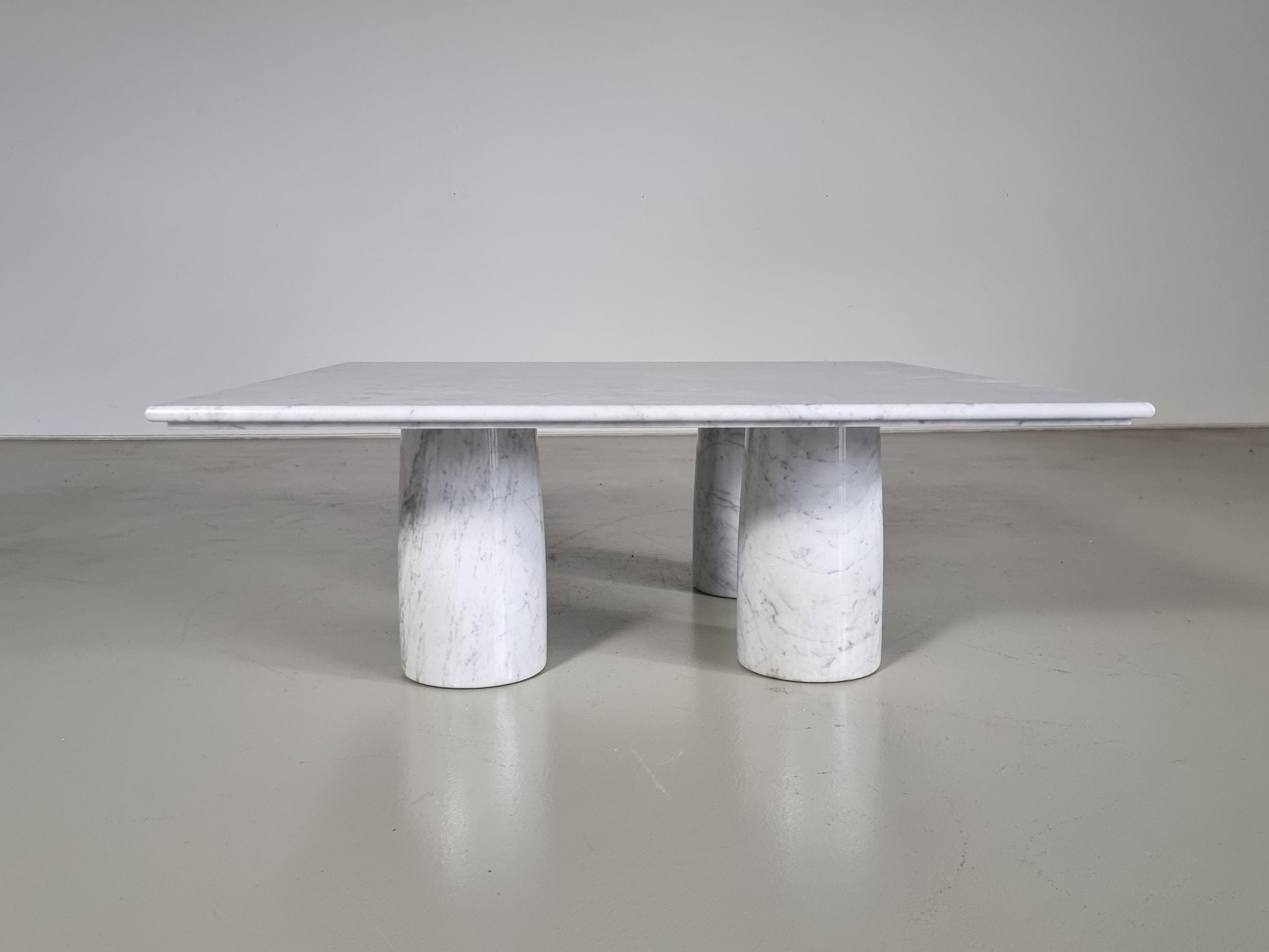 'Il Colonnato' coffee table in Carrara marble by Mario Bellini for Cassina. 

The table features a thick square white marble top with distinct gray veining. There are four thick column legs that support the tabletop and can be placed in different