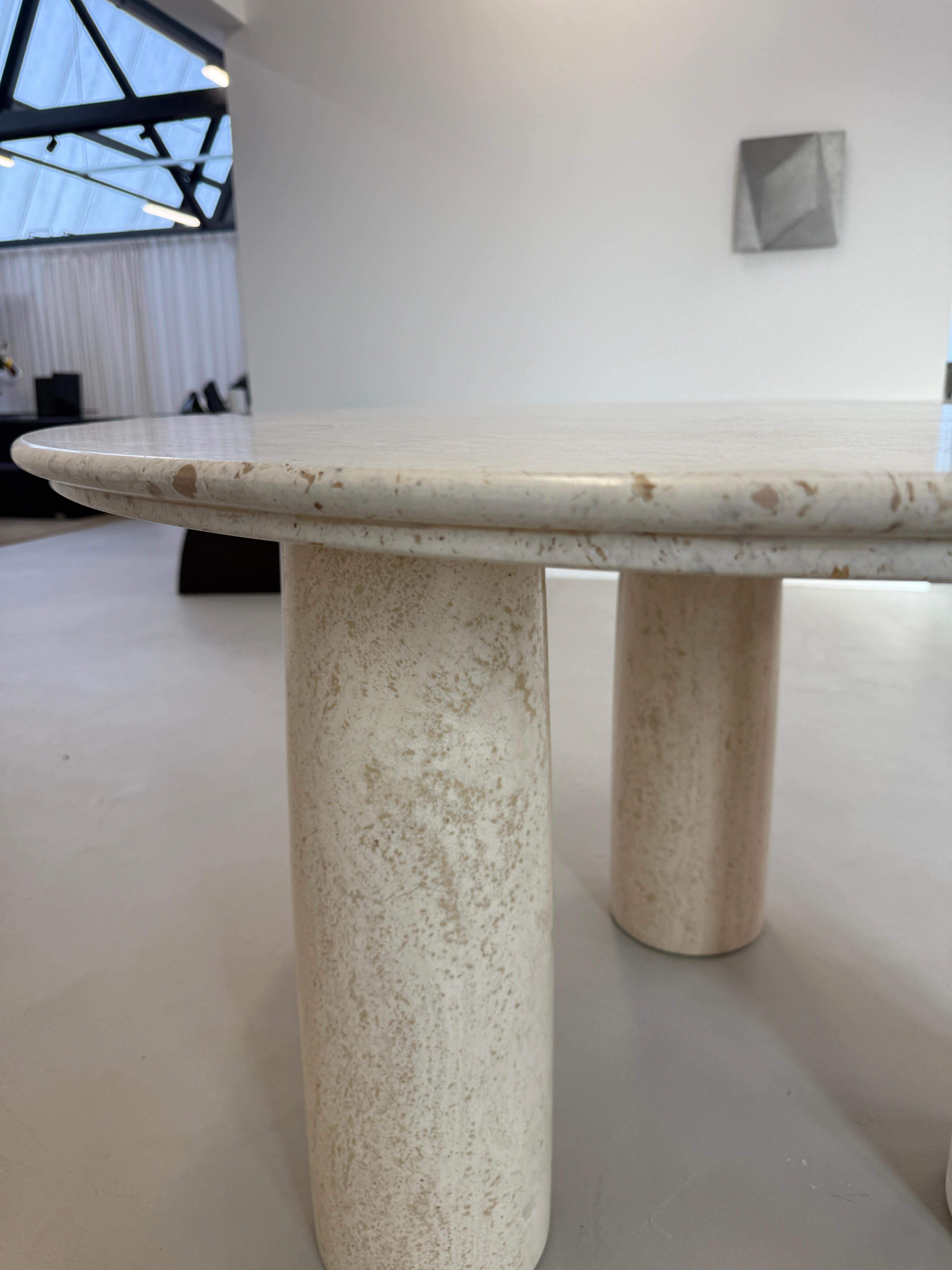 Inspirée des colonnades de la Rome antique, la table de salle à manger Il Colonnato, rare et de collection, a été conçue par Mario Bellini pour Cassina, vers 1977. 

Le plateau rond en marbre travertin présente une arête distinctive, tandis que les