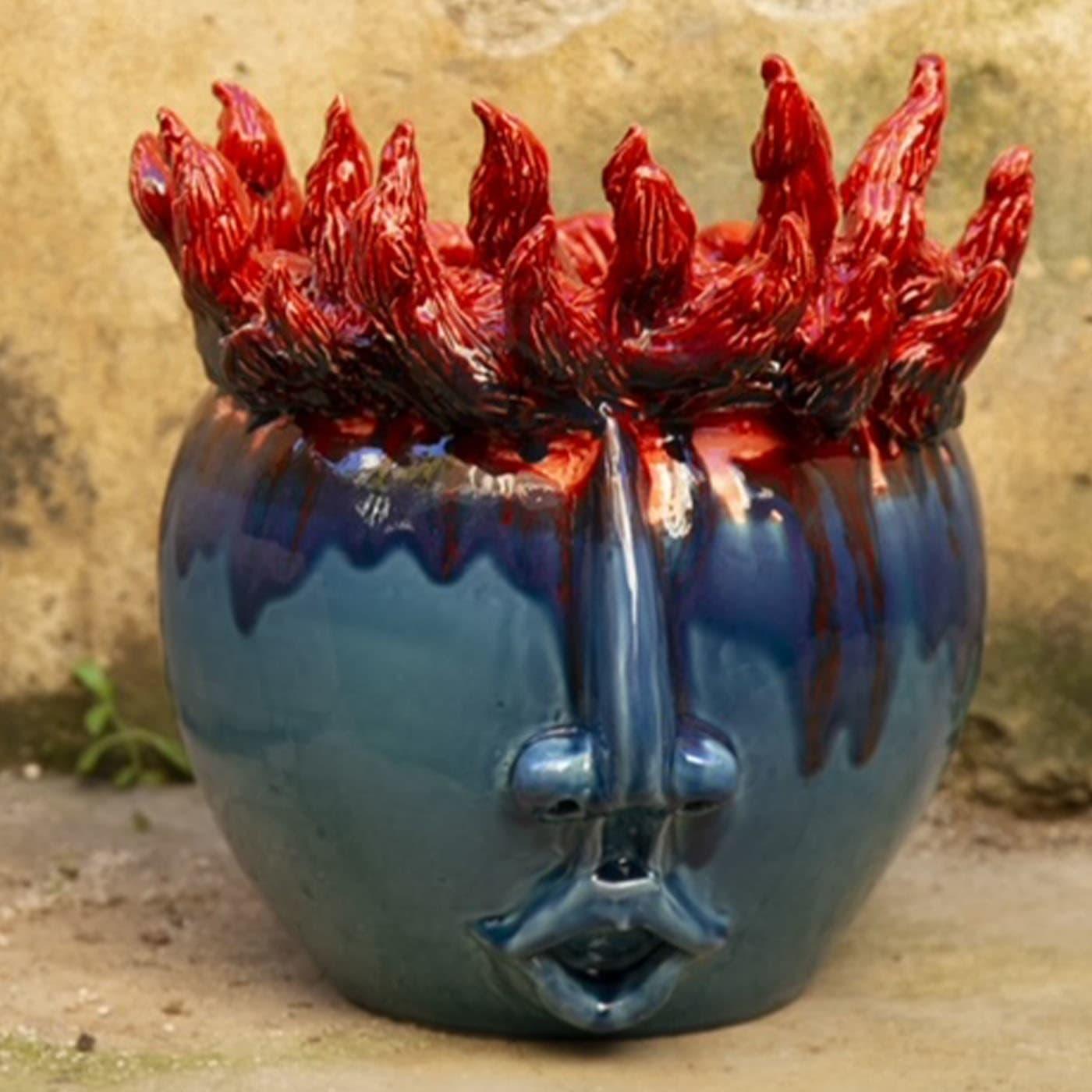 This vase is a representation of a Young Stoker, an apprentice in the art of fire. It makes the Sicilian skies shine on festive nights and its fire is always good and warm and full of passion.