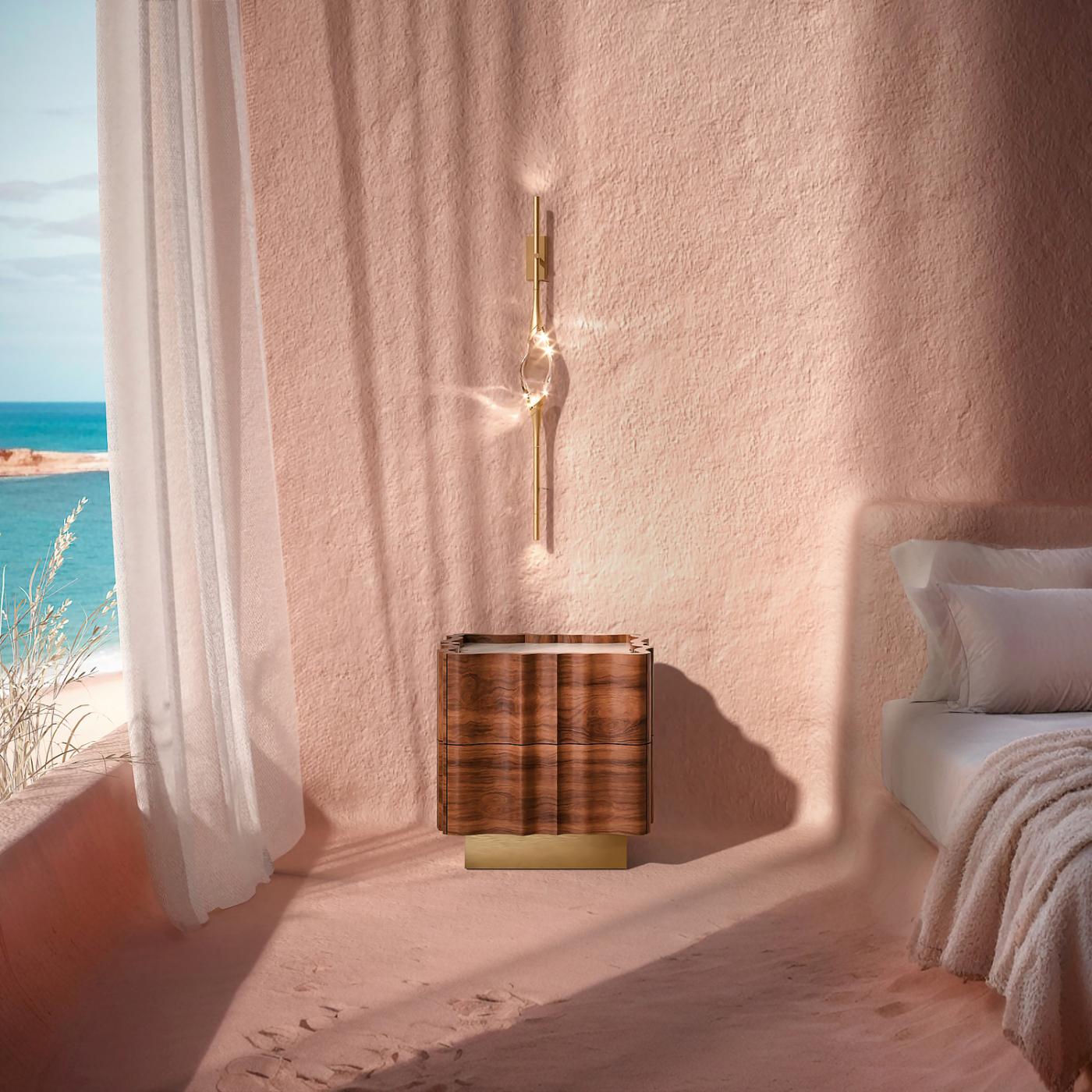 The solid clearest crystal, suspended between brass stems and brass casting rings in gold finishings, Il Pezzo 12 Wall Sconce creates diffused ambient lighting. At the top and end of each stem, two LEDs spread a warm direct light.Each lamp is