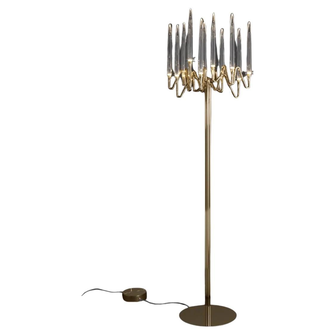 Il Pezzo 3 Floor Lamp, with a hand-crafted brass structure and elegant candles crafted from solid crystal lit from the inside with modern LED lights, creates a sophisticated and romantic atmosphere. In each piece a small brass cylinder carrying a