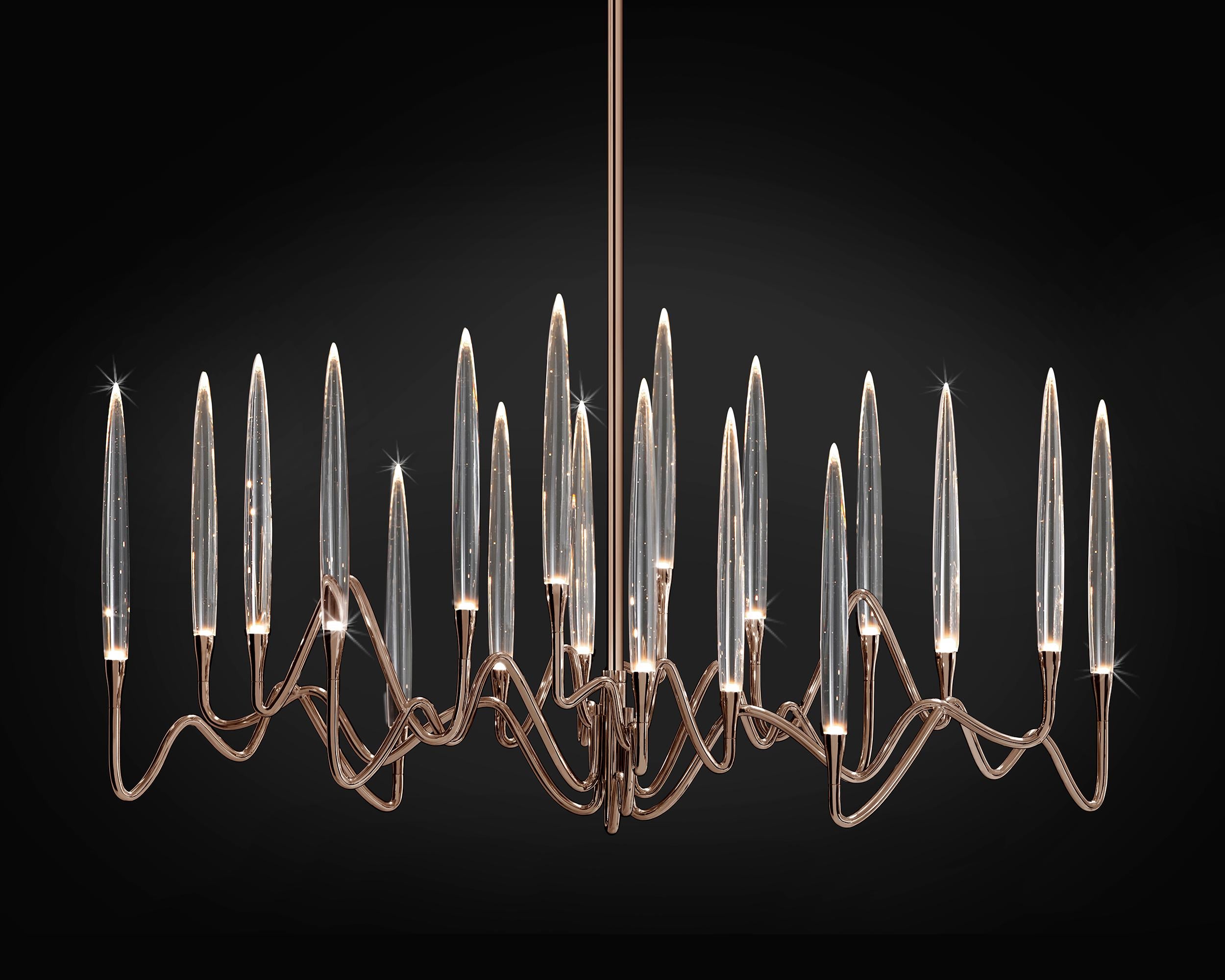 Inspired by Arabic calligraphic art and the icon of the classical candelabrum is Il Pezzo 3, a collection of lamps with a hand-forged brass structure and elegant “candles” crafted from hand blown crystal, according to the noble Tuscan artisan