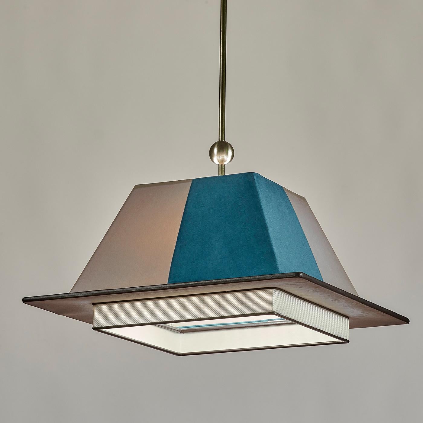 Part of the Chapeau Collection inspired by the shapes of hats, this sophisticated pendant light is reminiscent of the traditional graduation CAP. Pairing unconventional materials, this piece features a trapezoidal top in alternating ice blue and