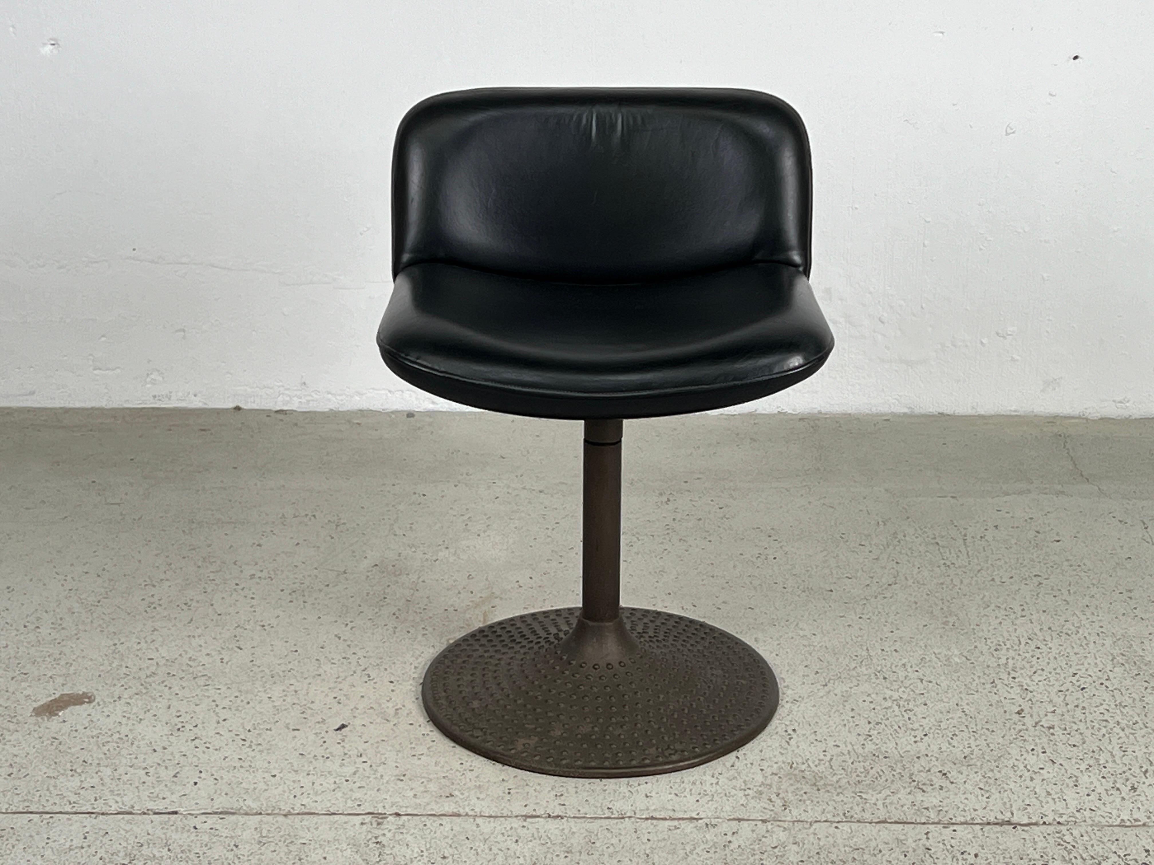 A swiveling stool  / chair with patinated base and original leather upholstery. Designed by Ilamari Tapiovaara. 