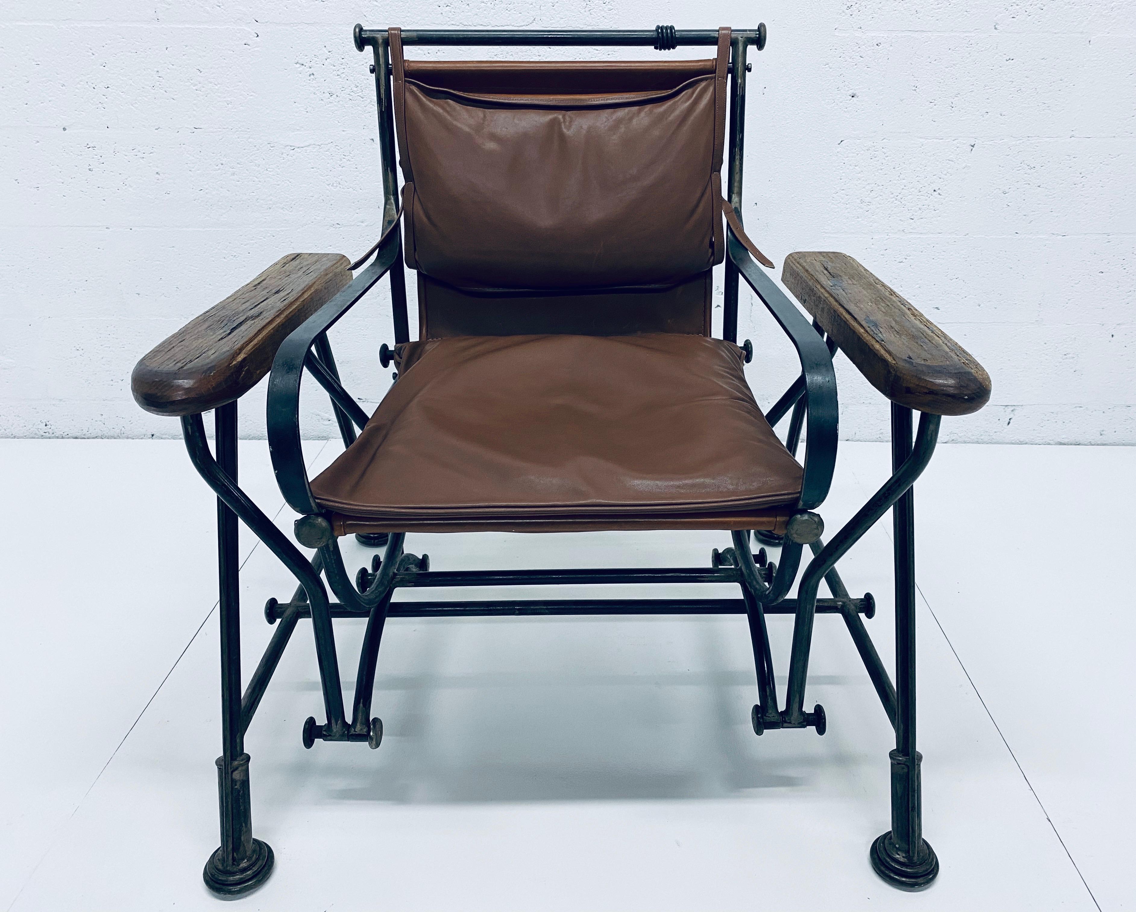 Rare and collectible Ilana Goor brown leather and iron glide (moves back and forth) arm chair. Signed.

Ilana Goor is an individualistic, autodidactic, intuitive and multifaceted artist. As an artist who knows no boundaries and whose art transcends