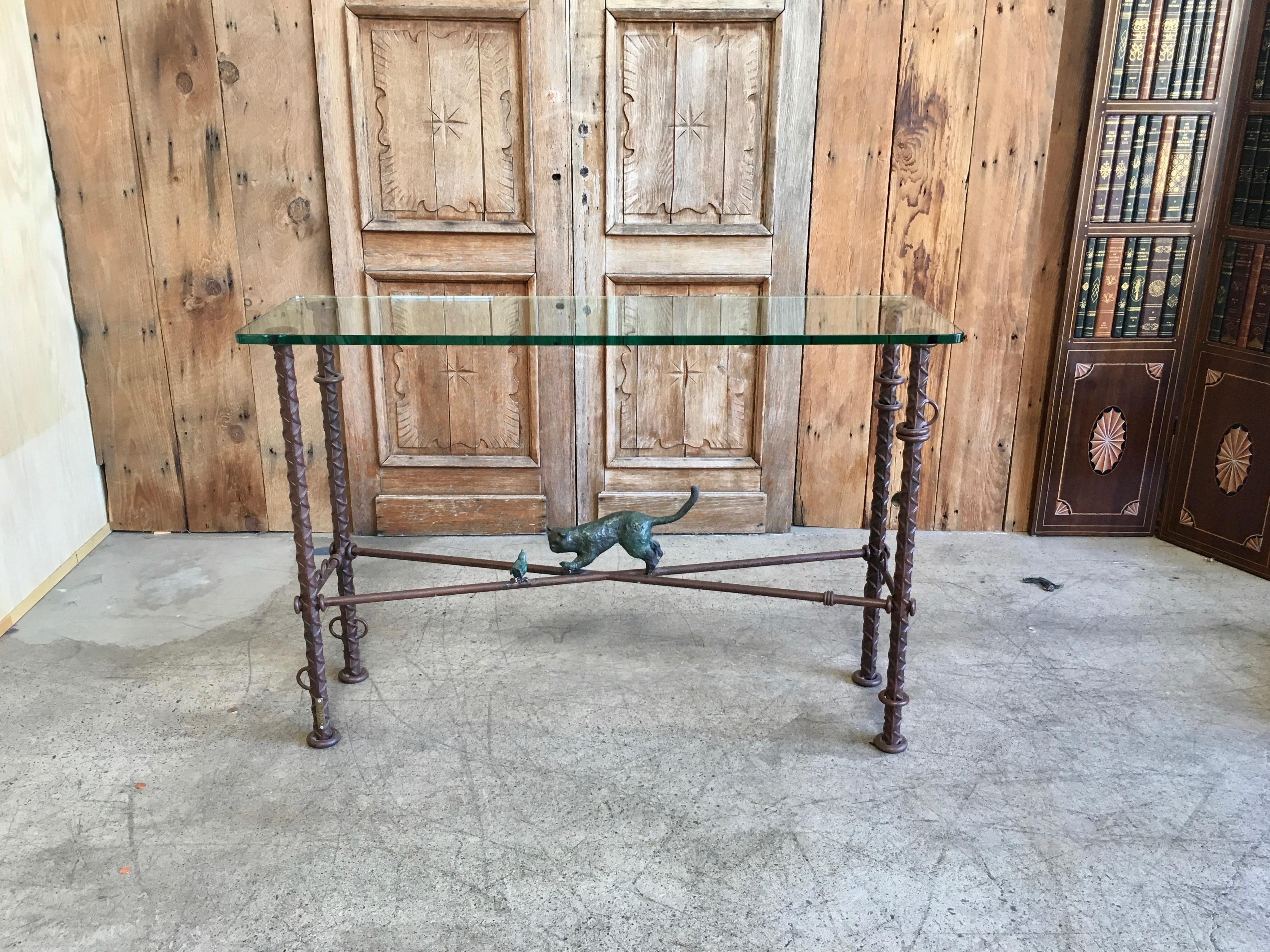 Very popular artist Ilana Goor console table made of iron with bronze cat and bird in a playful scene topped with glass
Signed on the cat and the leg of the table.