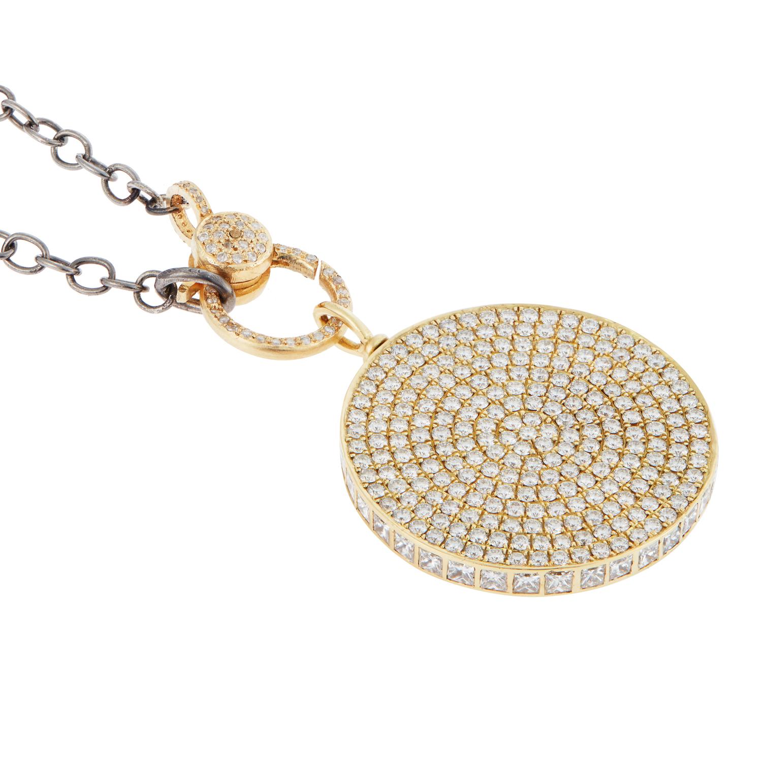 Handcrafted of 18k yellow gold this Ice Candy pendant rotates on its hoop and is set on one side with sparkling concentric circles of pavé white diamonds, satin-finished on the other side with three bezel-set baguette diamonds set in the center and