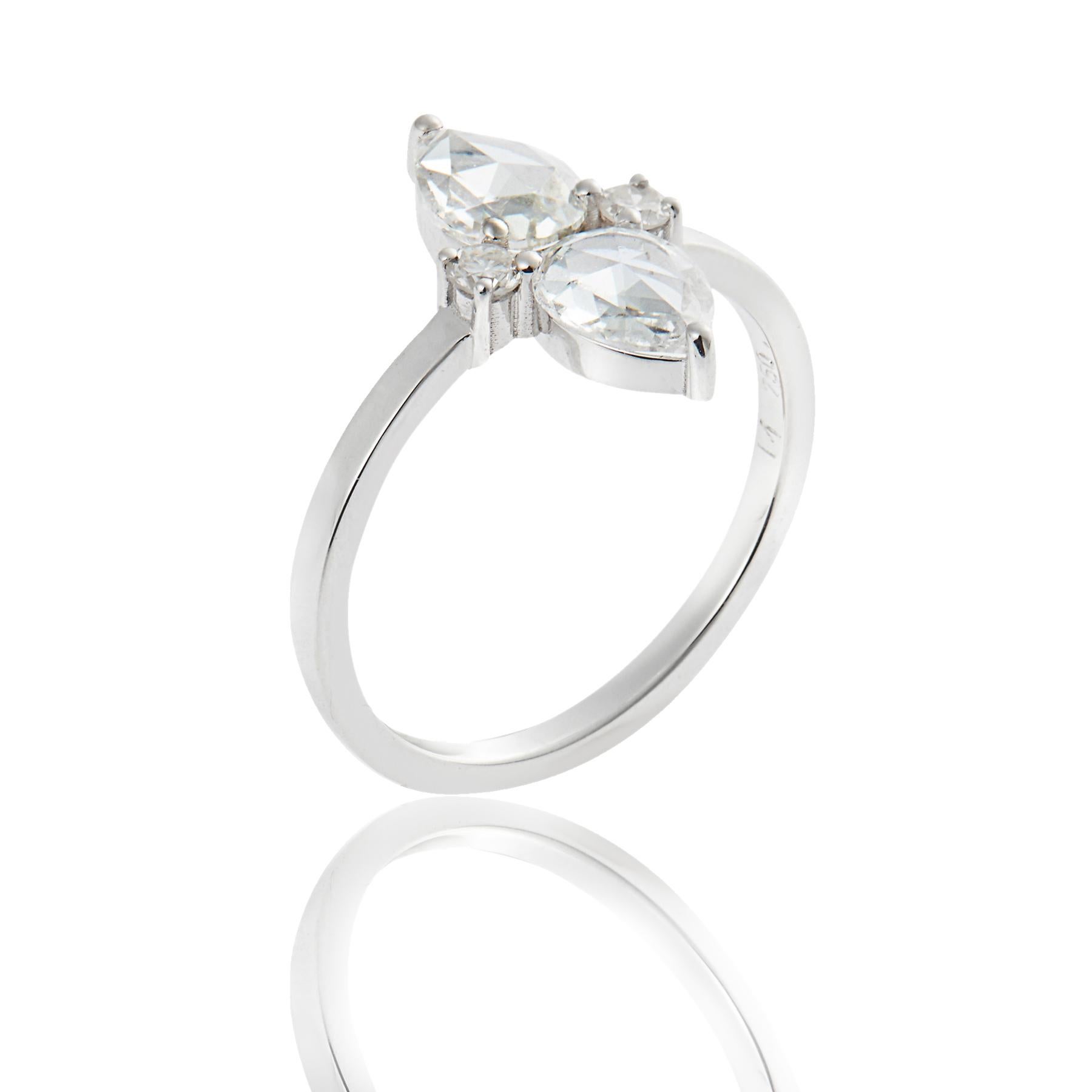 Handcrafted from 18k white gold, this stunning diamond ring features two prong-set, pear-shaped rosecut diamonds embellished with two smaller brilliant cut diamonds.