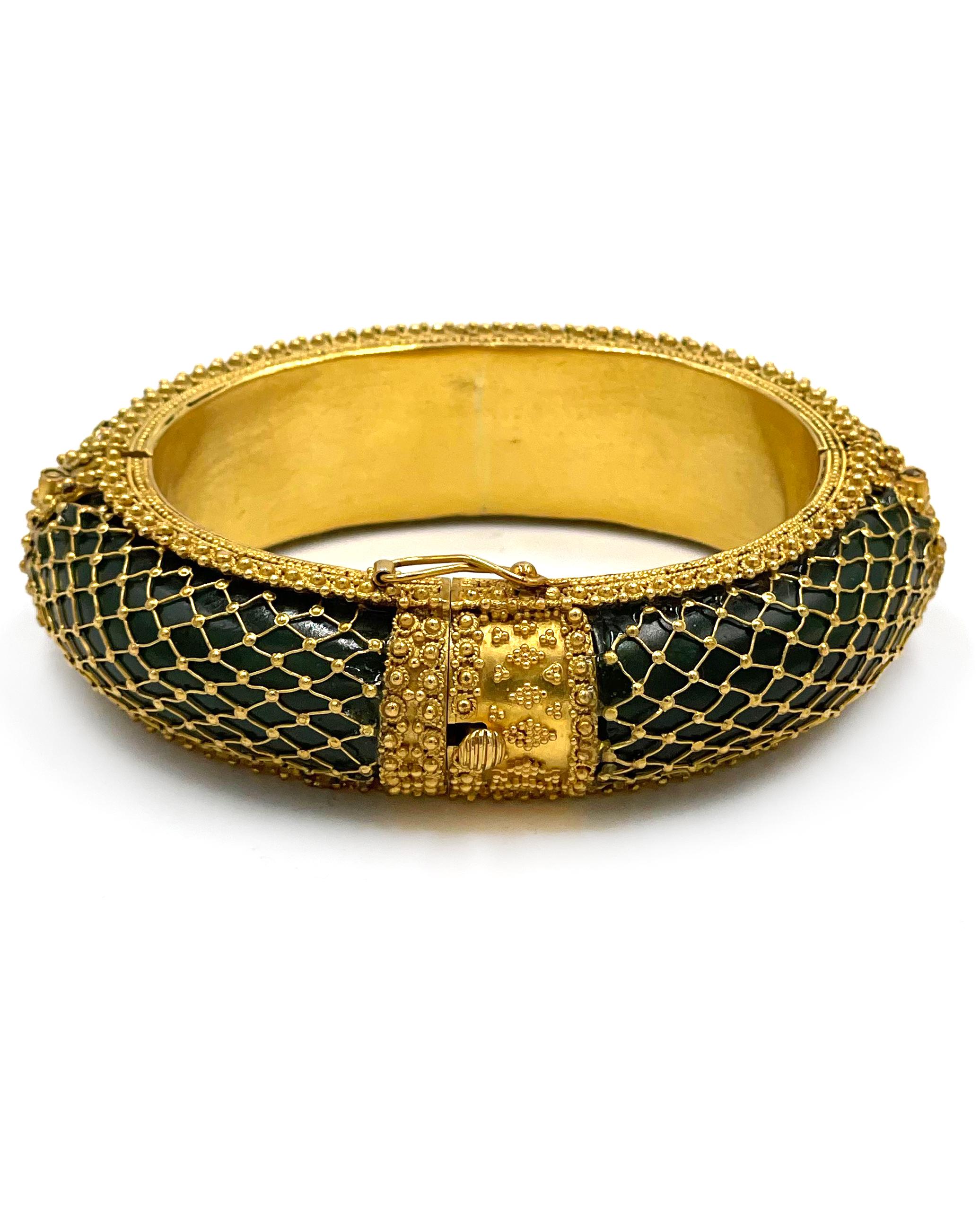 Pre owned vintage estate 18K yellow gold nephrite jade hinged bangle bracelet by Ilias Lalaounis.  The jade is a curved half round oval in three sections.  The jade measures 19.3mm wide and 8.8mm high.  The three sections are fitted into a frame and