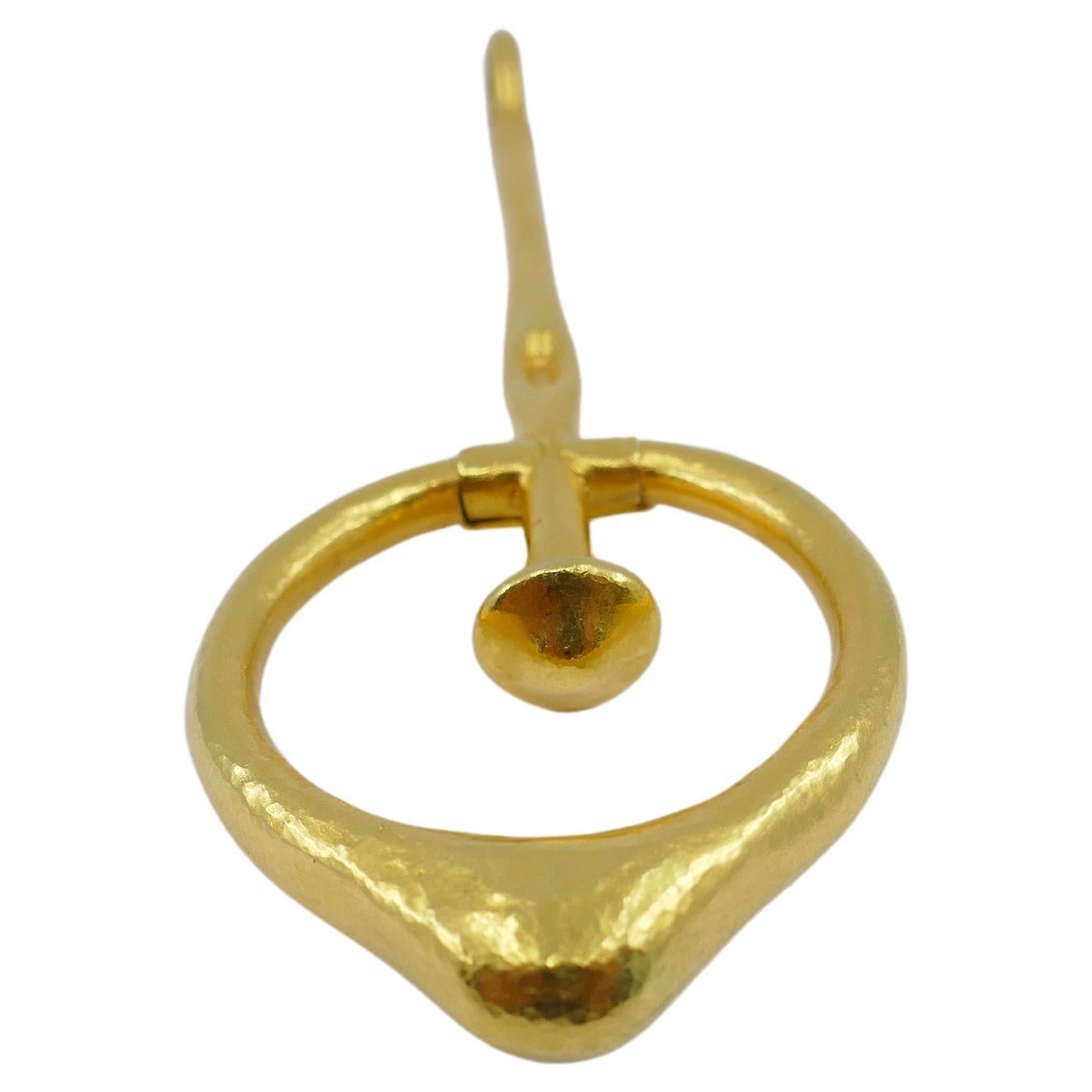 A unique 18k gold pendant by Ilias Lalaounis. The piece is crafted as a pendulum with a dangling, drop-shaped circle part. This Lalaounis pendant can be referred to as one of the ancient pendulums that were worn for protective and luck-providing