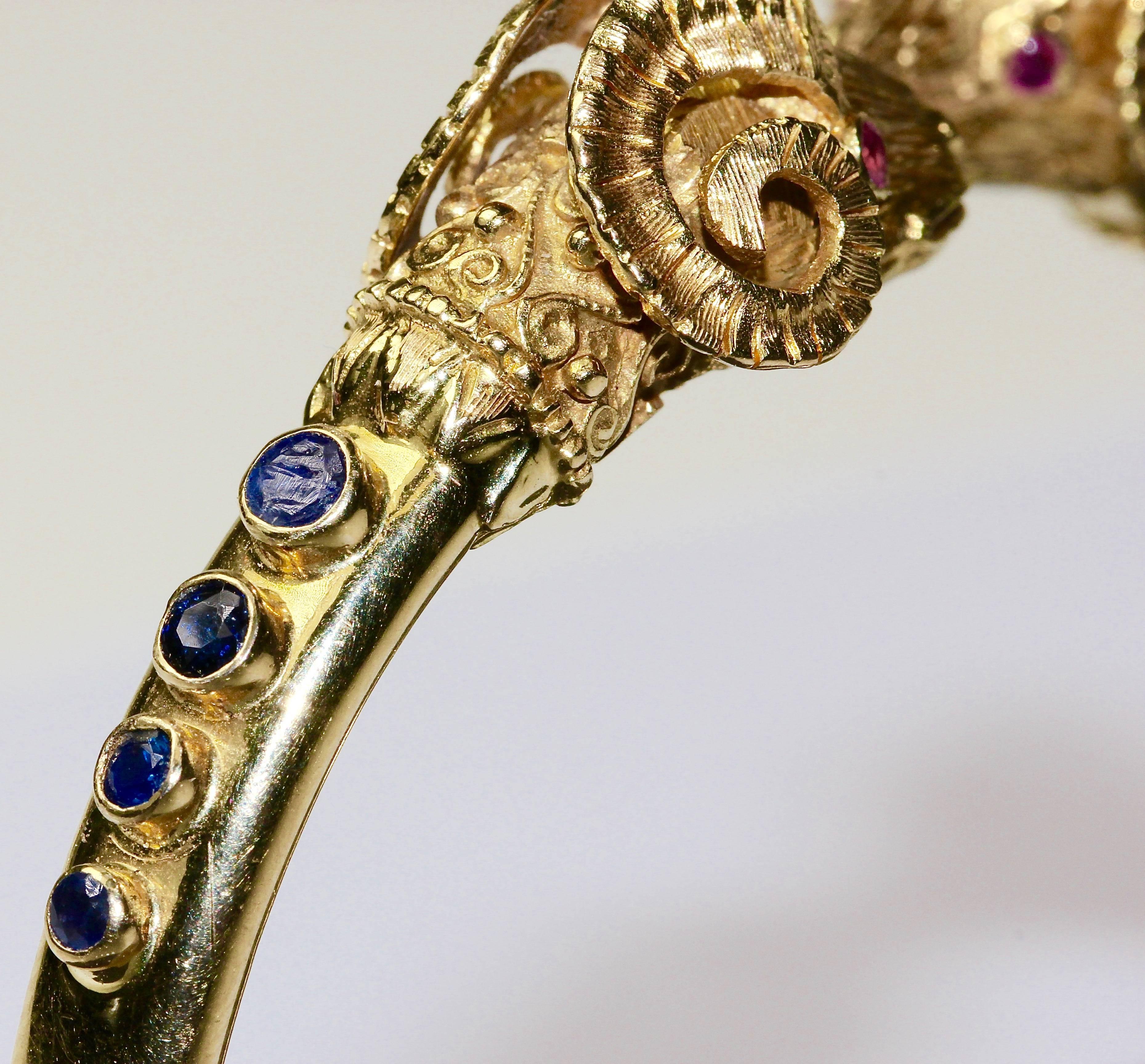 Exclusive bangle of the noble designer Ilias Lalaounis, made of 18k yellow gold. Set with eight sapphires and four rubies (as ram's eyes).
Hallmarked. Very good condition.