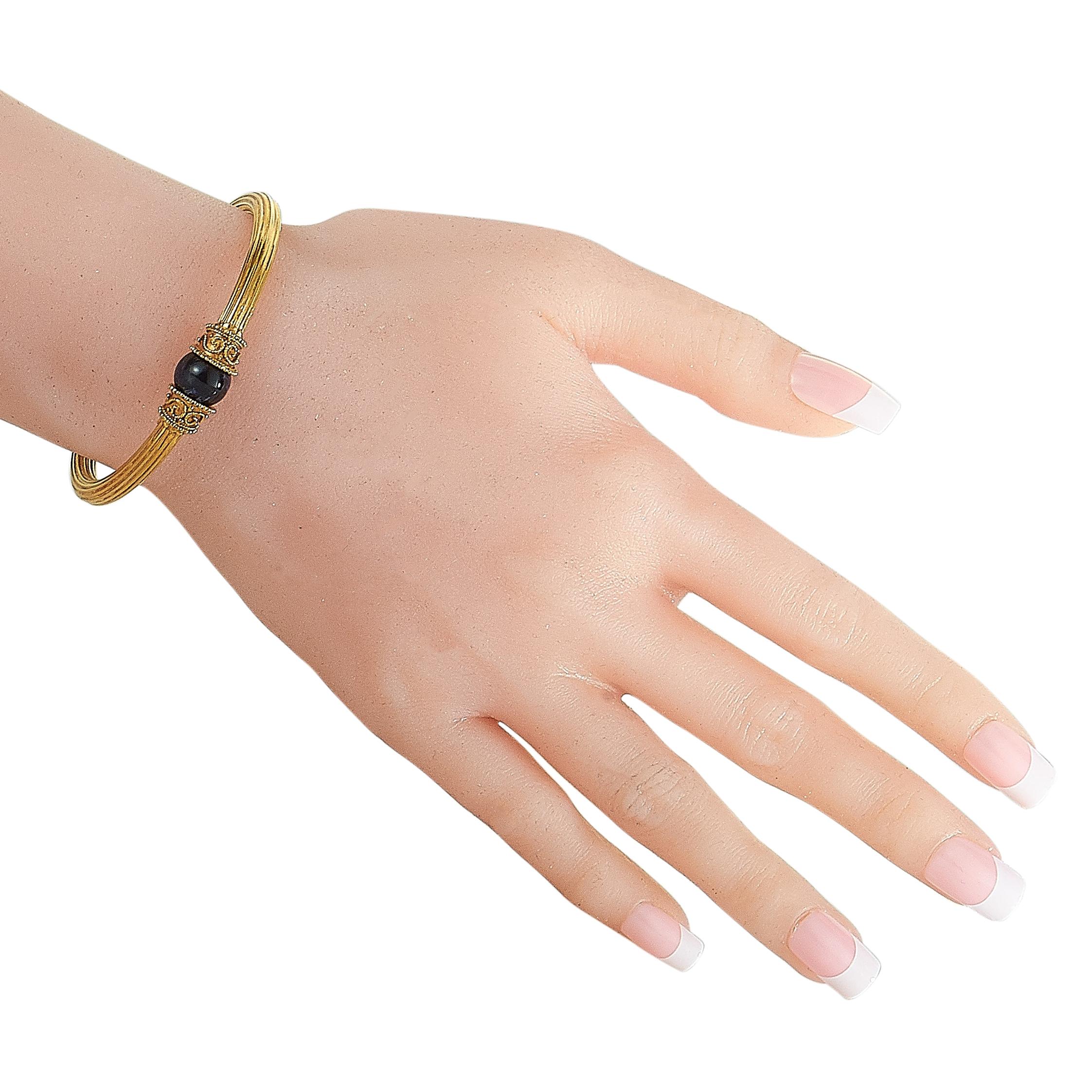 This Ilias Lalaounis bracelet is made out of 18K yellow gold and lapis lazuli and weighs 20.2 grams, measuring 7” in length.
 
 The bracelet is offered in estate condition and includes a gift box.