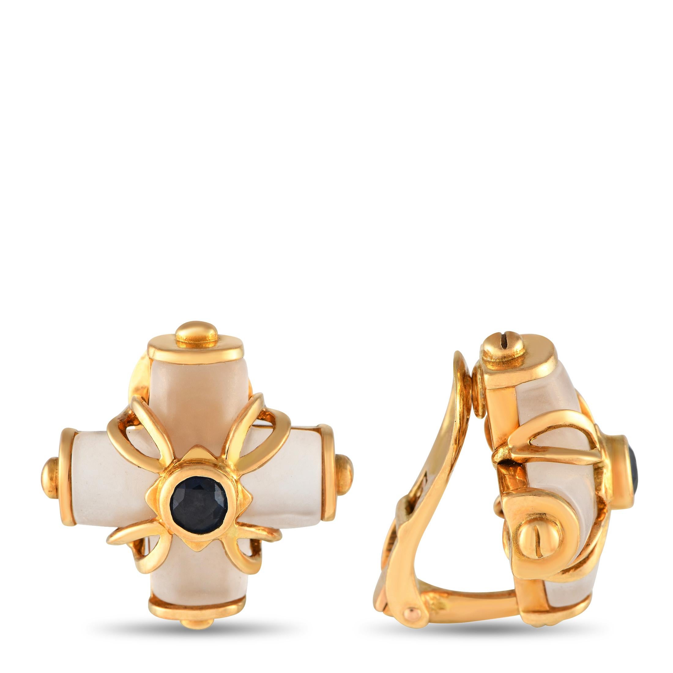These Ilias Lalaounis earrings are simple, stylish, and statement making. Each one features an elegant 18K Yellow Gold setting that measures 0.75 round and is accented by sparkling Crystal and Sapphire accents.This jewelry piece is offered in estate