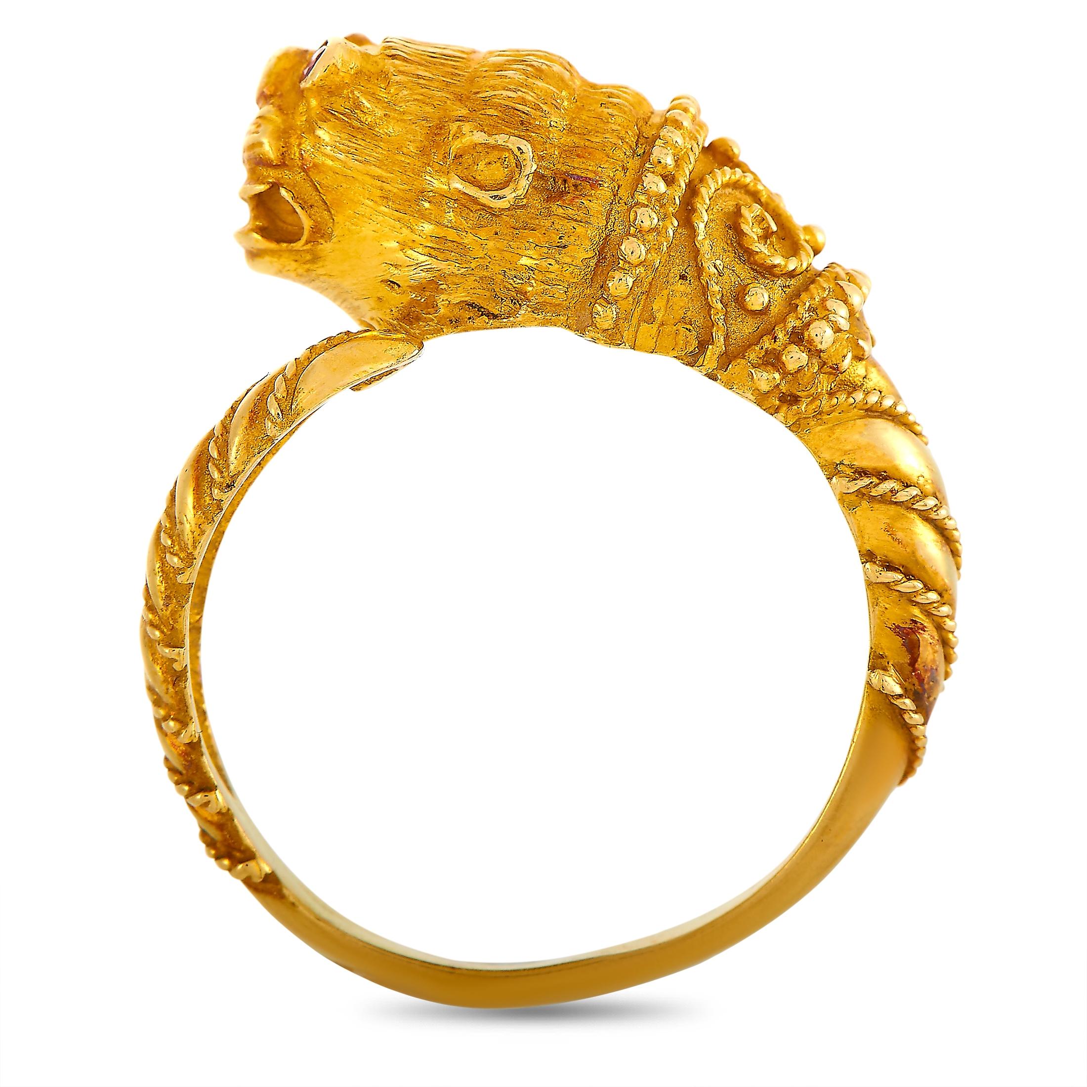 This Ilias Lalaounis ring with a lion head motif is crafted from 18K yellow gold and weighs 8.1 grams. It boasts band thickness of 3 mm and top height of 8 mm, while top dimensions measure 10 by 20 mm.
 
 The ring is offered in estate condition