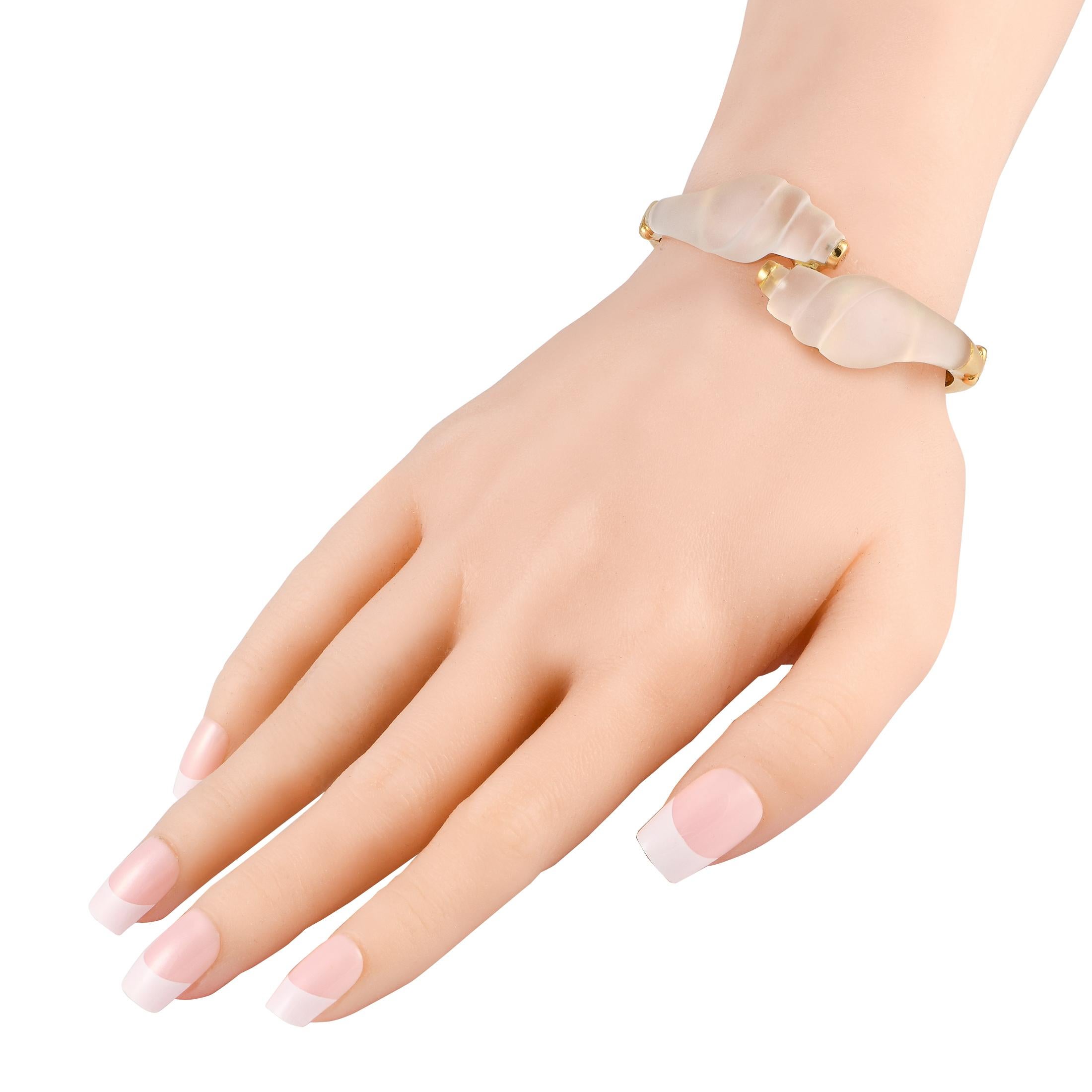Made by internationally renowned Greek jewelry designer Ilias Lalaounis, this bypass-style bangle bracelet reflects the excellence of Athenian craftsmanship. It features a solid yellow-gold bangle with crossing-over ends decorated with sculpted