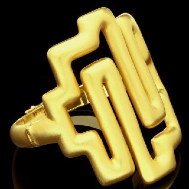 A bold geometric 22ct yellow gold bracelet from the 'Choreographism' collection by Ilias Lalaounis 1977, the solid bangle style bracelet with a large geometric openwork motif at the front in the form of a labyrinth, hinged at both sides and with