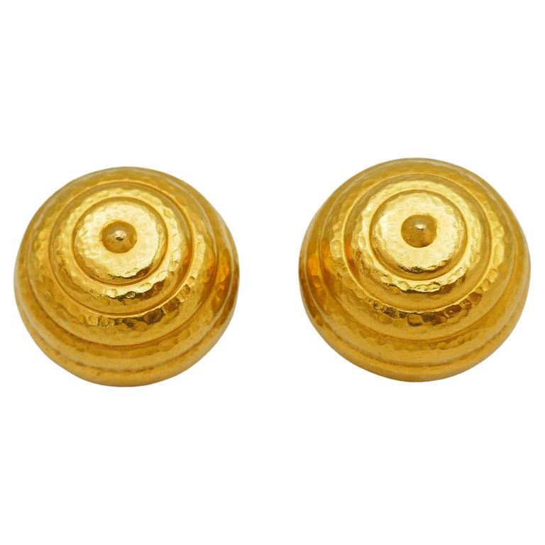 A pair of button clip-on earrings by Greek designer Ilias Lalaounis. Made of 22k gold, with Lalaounis' signature hammered texture. Stamped with the maker's mark and a hallmark for 22k gold.
Measurements: diameter is 3/4