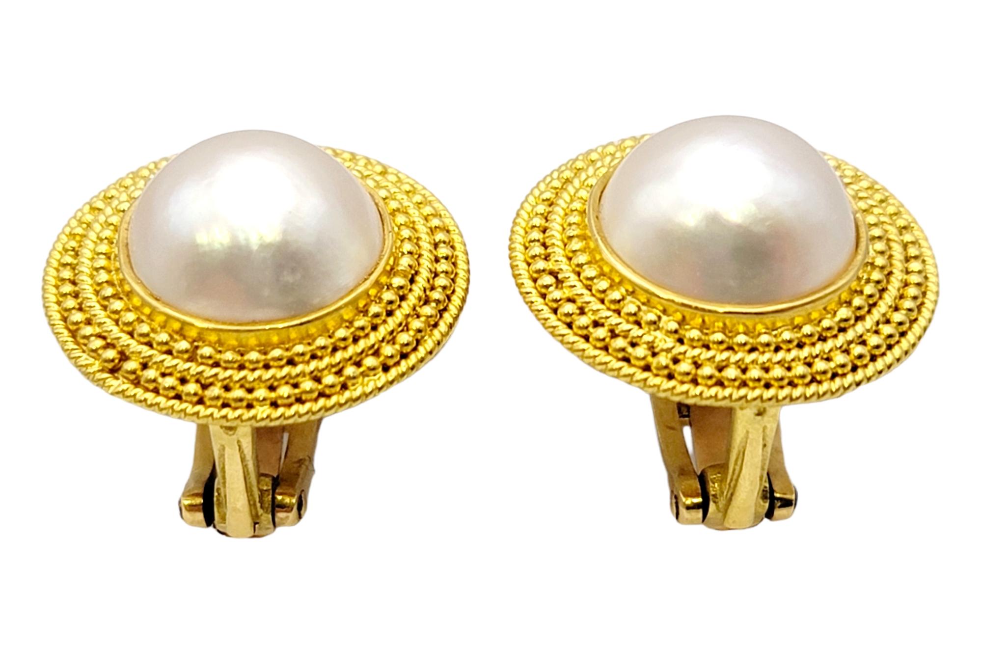 Sophisticated clip-on earrings by Greek jewelry designer, Ilias Lalaounis. These elegant beauties feature gorgeous cultured Mabe pearl centers with slight pink overtones. Textured 18K yellow gold surrounds the pearls, framing the stones beautifully